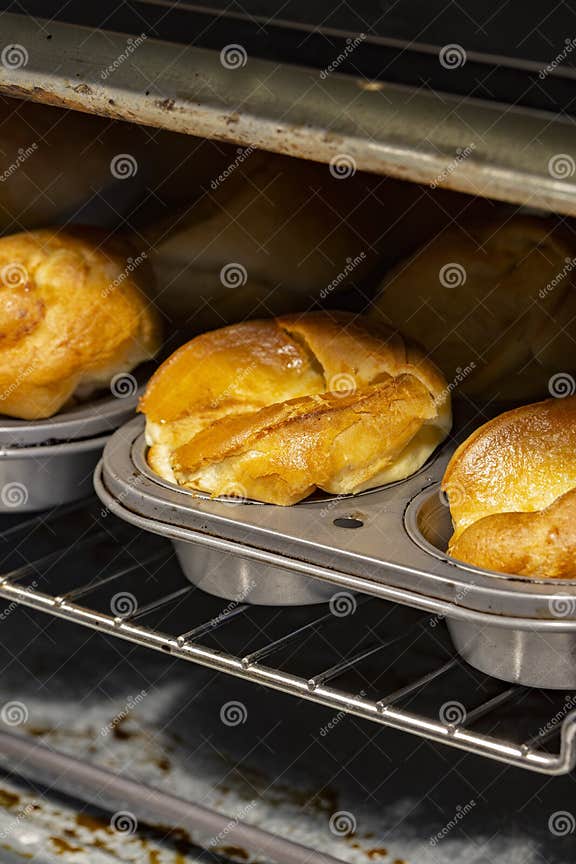 Individual Yorkshire Puddings Cooking in an Electric Oven. Stock Photo
