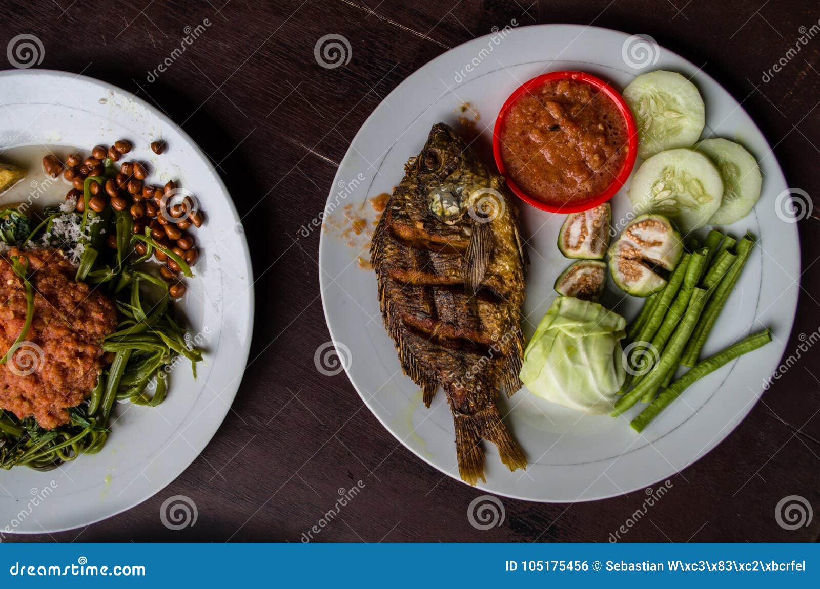 indonesian food: kankung plecing spicy water spinach dish and ikan goreng fried fish top view