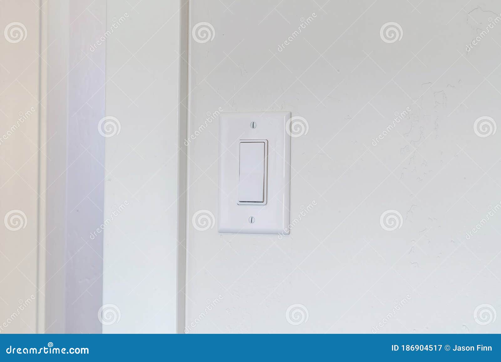 Indoor Electrical Light Switch of Home Mounted on White Wall Background