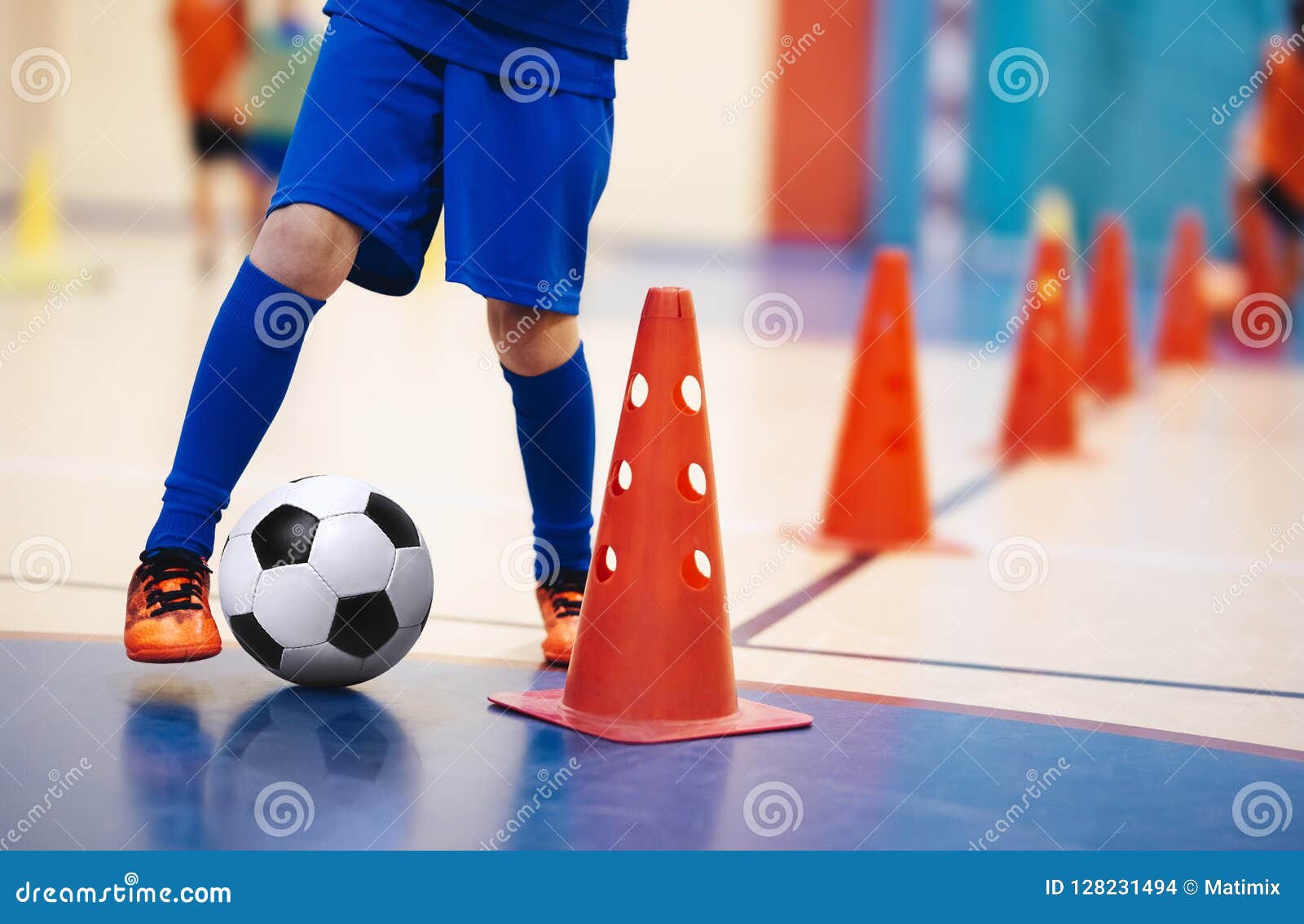 indoor soccer players training with balls. indoor soccer sports hall. indoor football futsal player