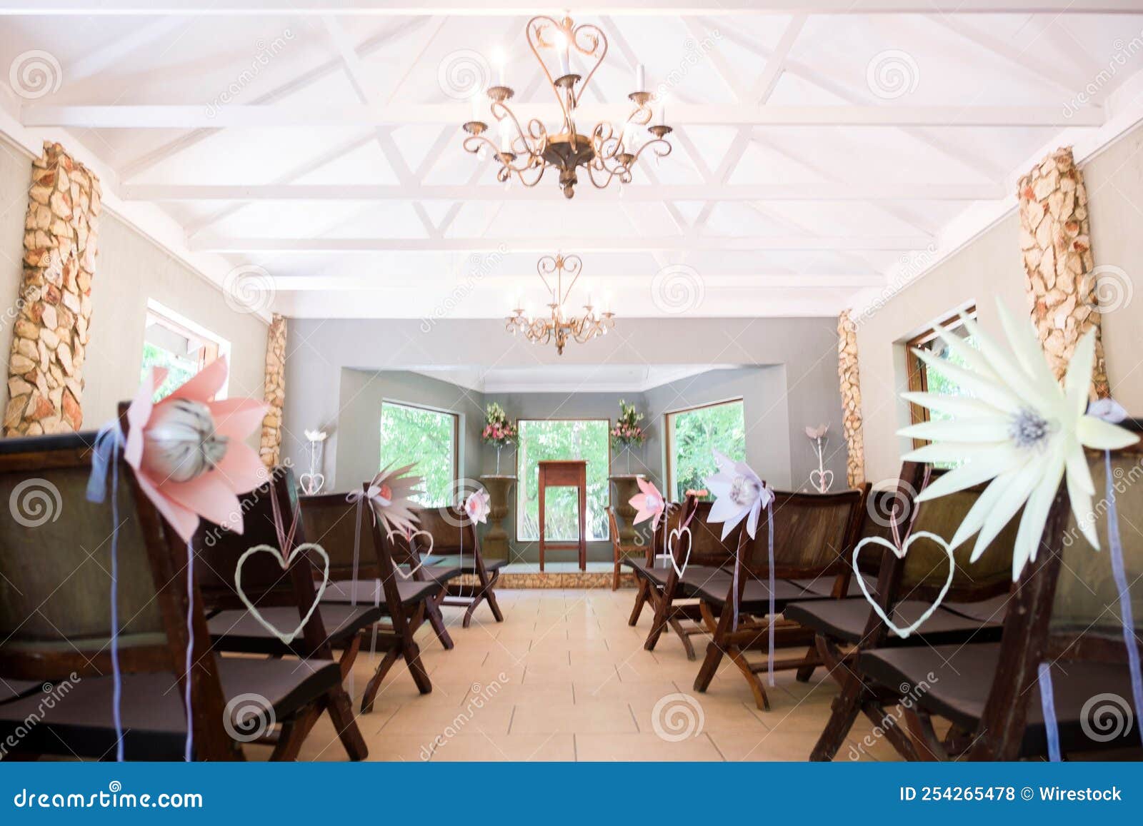 Indoor Wedding Venue with Beautifully Decorated Chairs Stock Photo