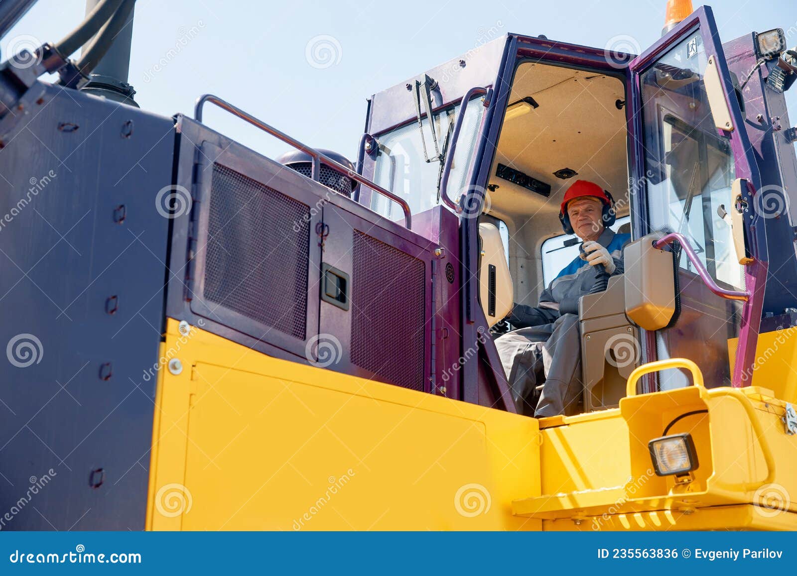 Industrial Bulldozer Driver Gets into Coal Loading Cab in Open Pit Mine