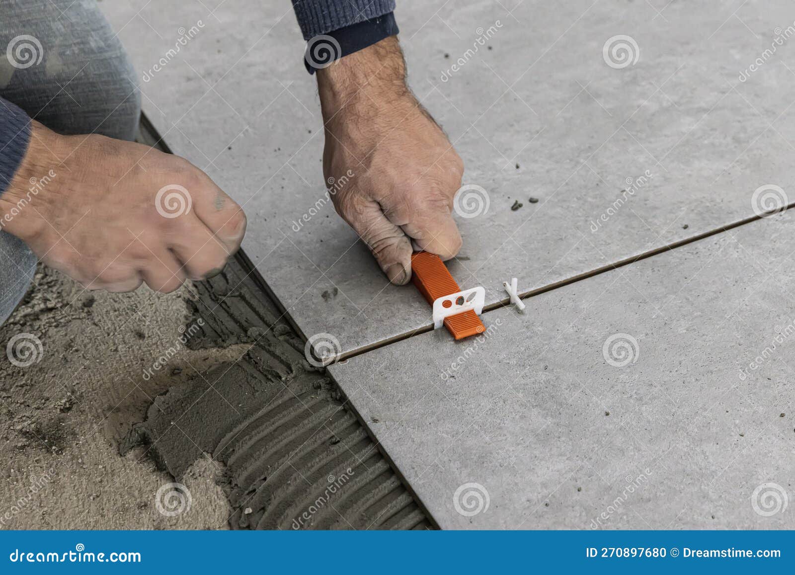 Industrial Ceramic Builder Worker Installing Floor Tile at Repair