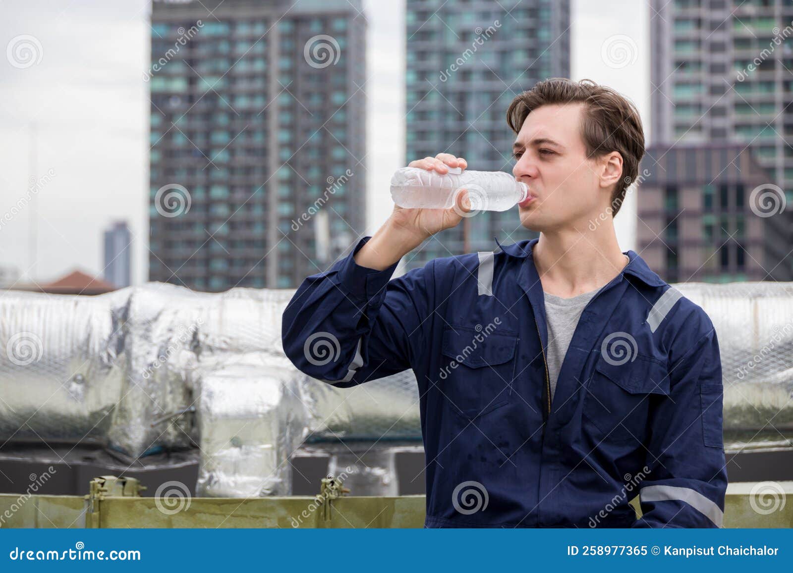 Industrial Engineer or Worker Drinking Water in Construction Site