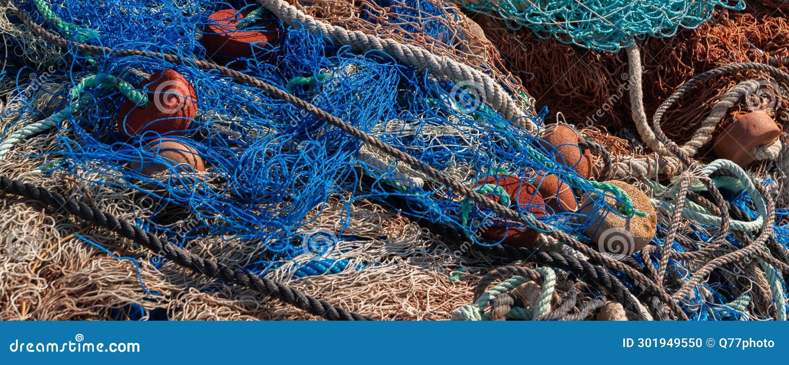 Industrial Fishing Equipment Fishnets and Fishing Lines Lying on Concrete  in the Port Stock Photo - Image of fishing, float: 301949550