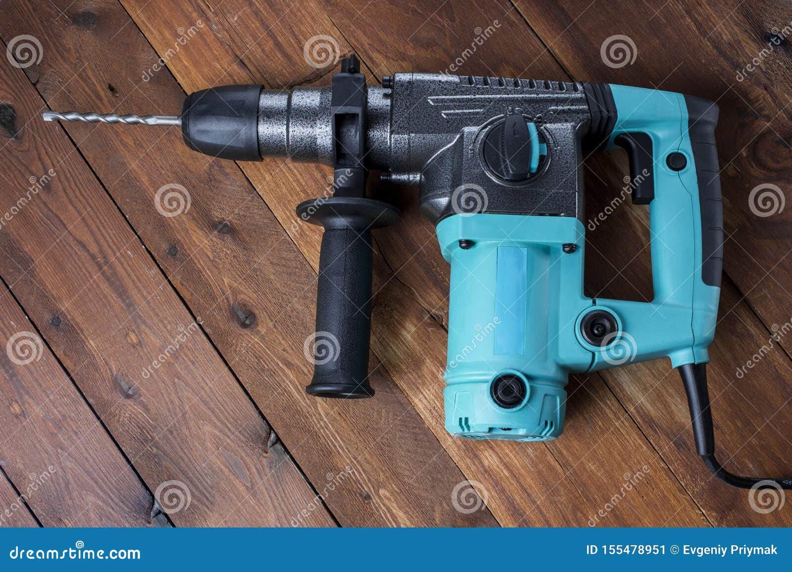 Industrial Hammer Drill. Perforator with a Drill on a Wooden Background