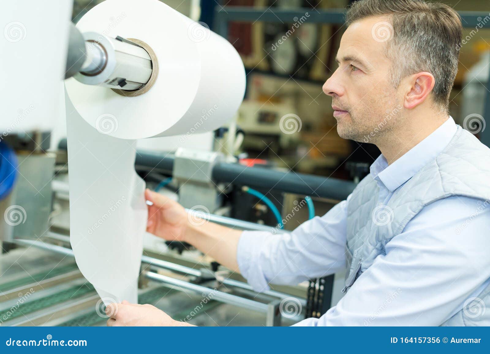 Industrial Printing Press Worker Looking at Rolled Paper Stock Photo Image of factory
