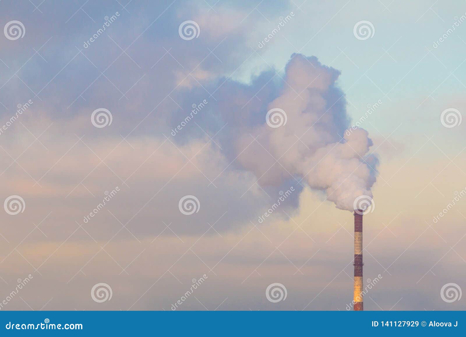 industrial smoke pipe on a sunny and cloudy sky