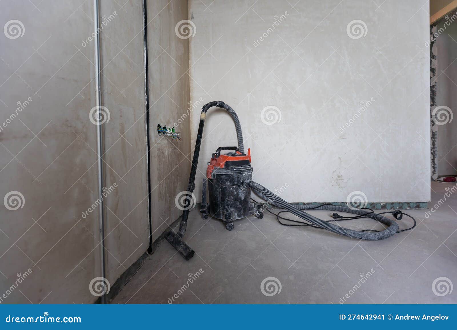 Industrial Vacuum Cleaner on the Dusty Floor of Construction Site