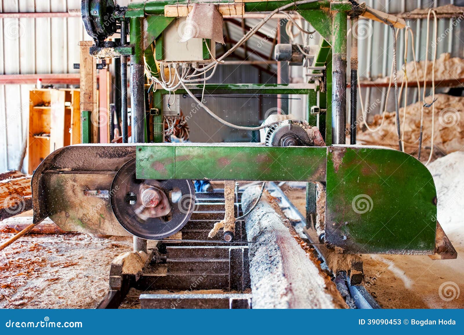 Industrial wood production factory - band saw sawmill being used to 