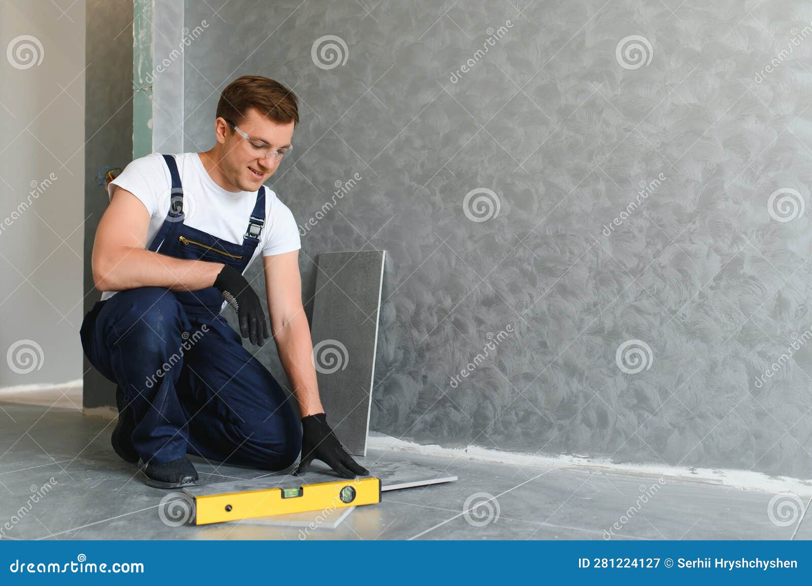 Industrial Worker, Handyman Installing Big Ceramic Tiles Stock Image