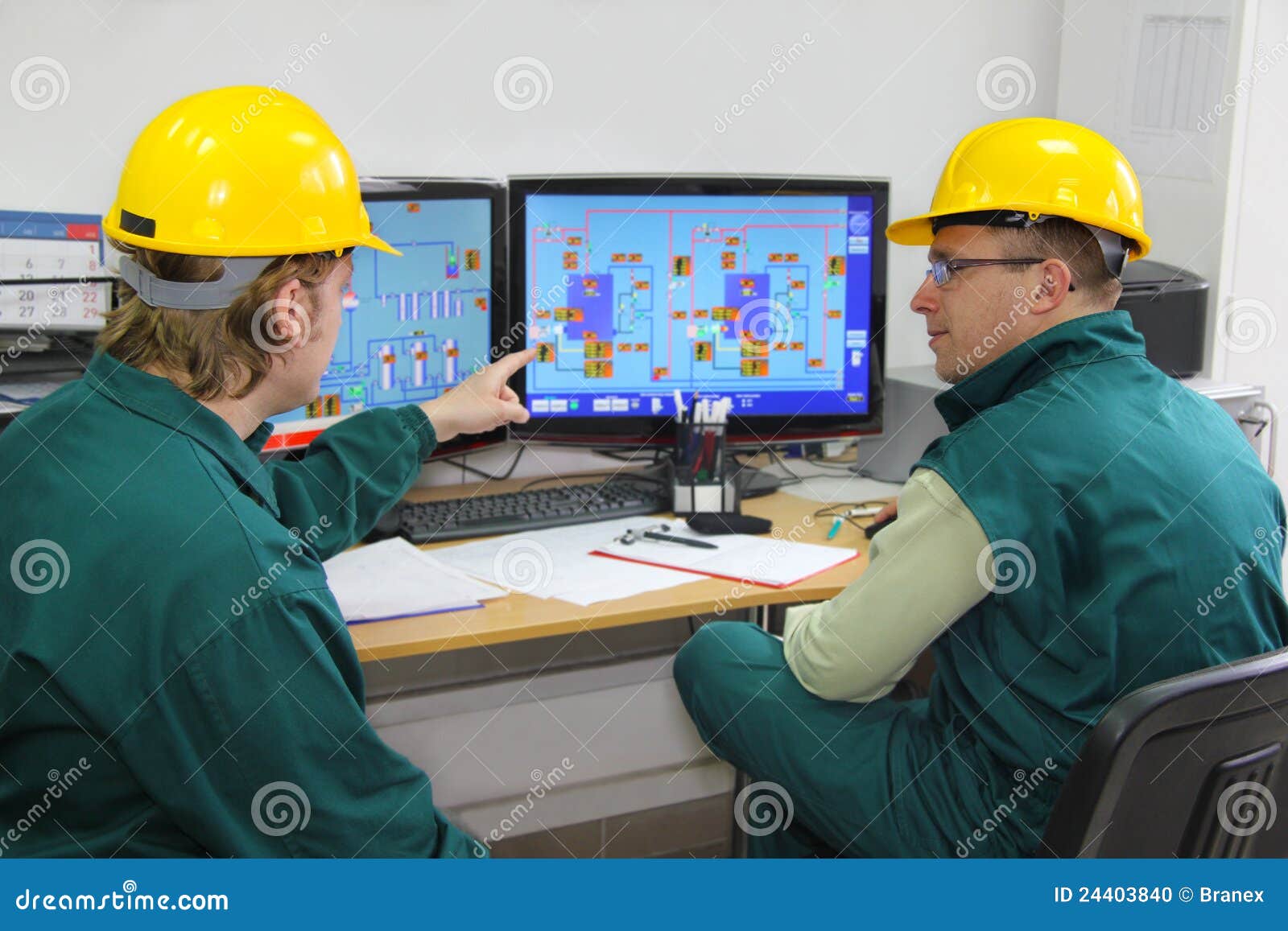 industrial workers in control room