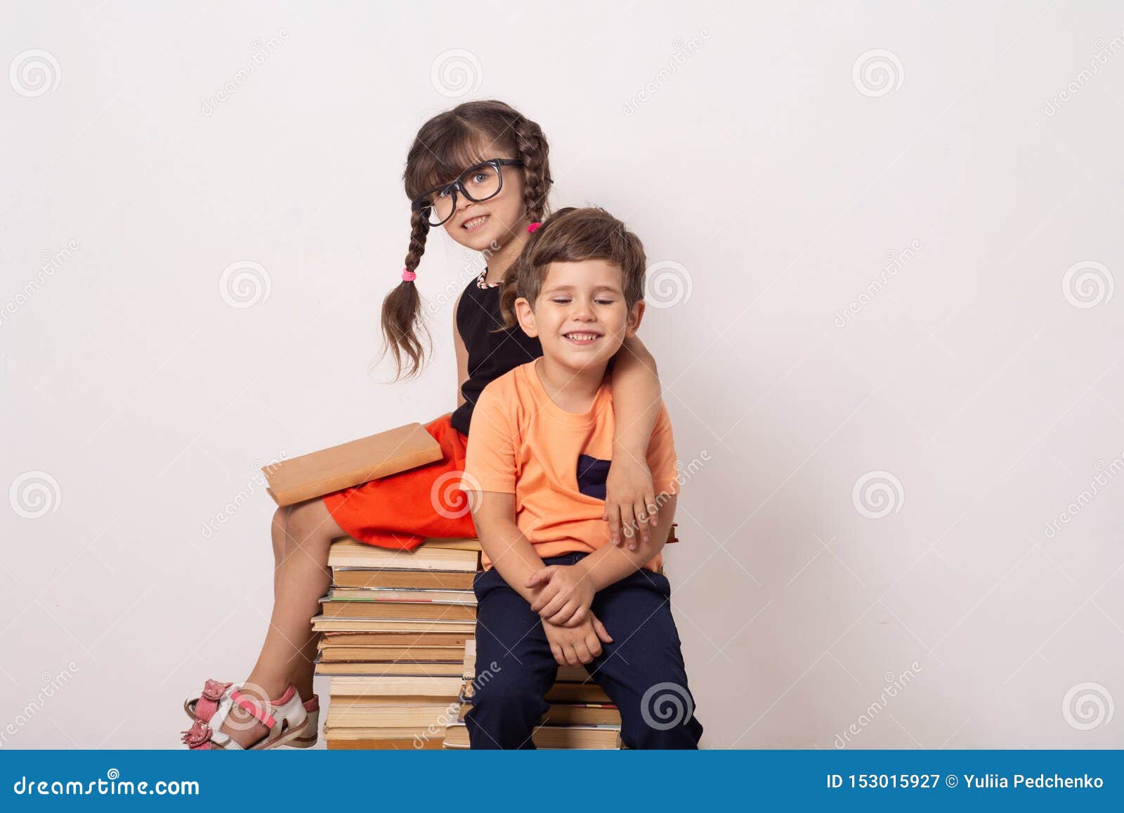 industrious child boy and girl with books. back to school creative background with school children.