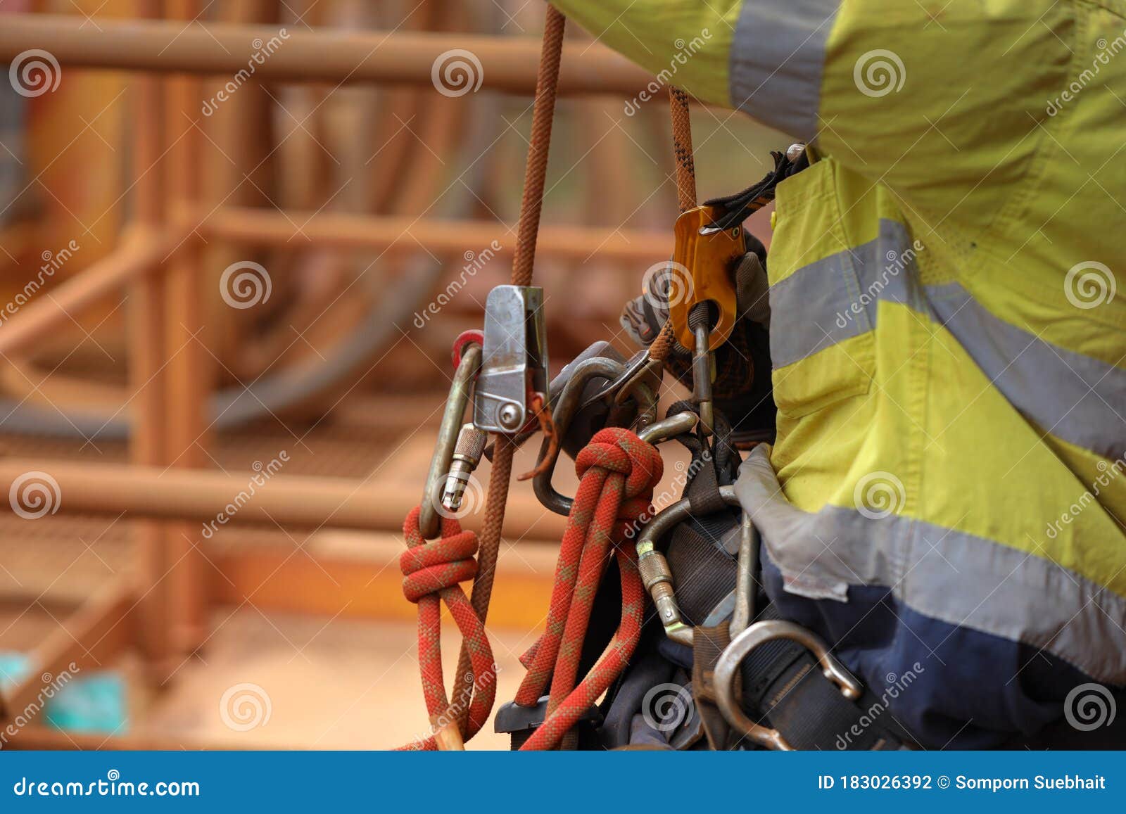 industry abseiler worker working at height abseiling removing rope from chest harness croll safety device