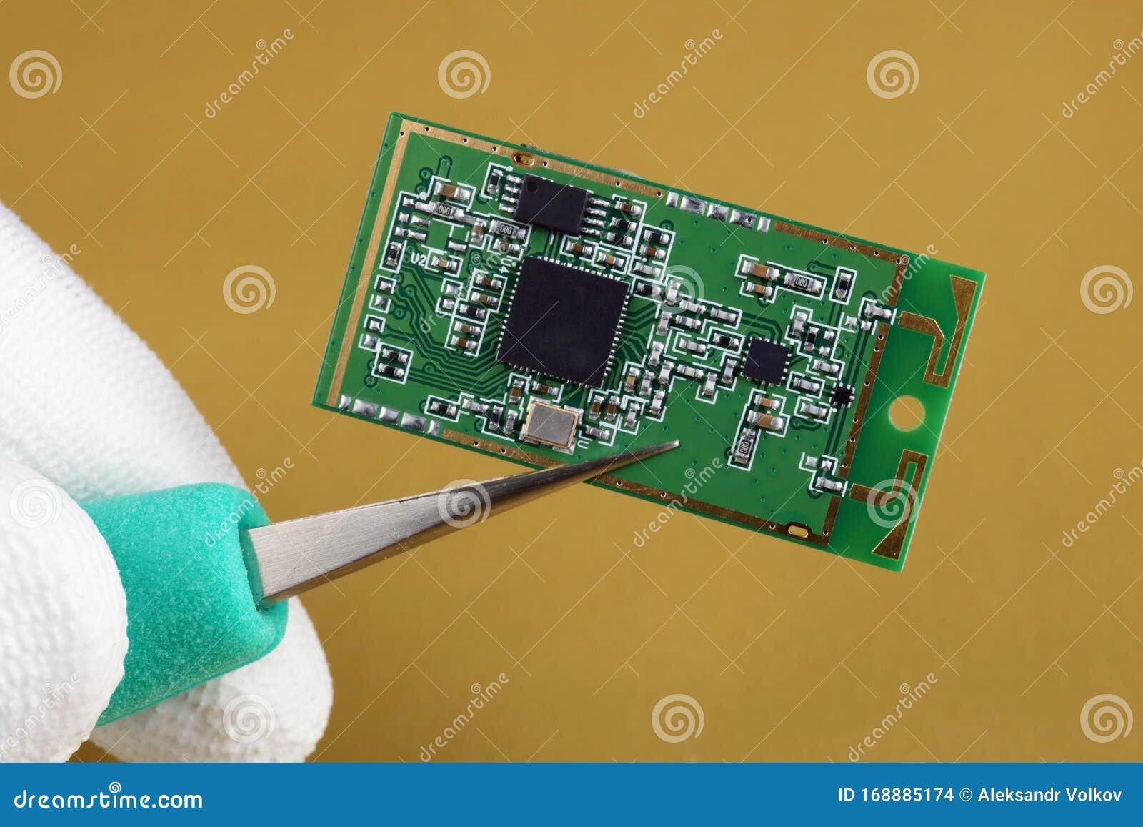 it industry engineer holds with tweezers mini wireless bluetooth  module for mobile devices macro