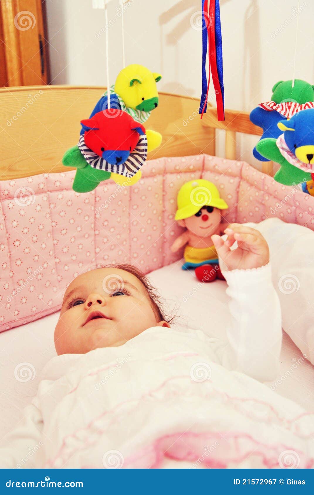 Infant in bed with toys stock image. Image of playful 21572967