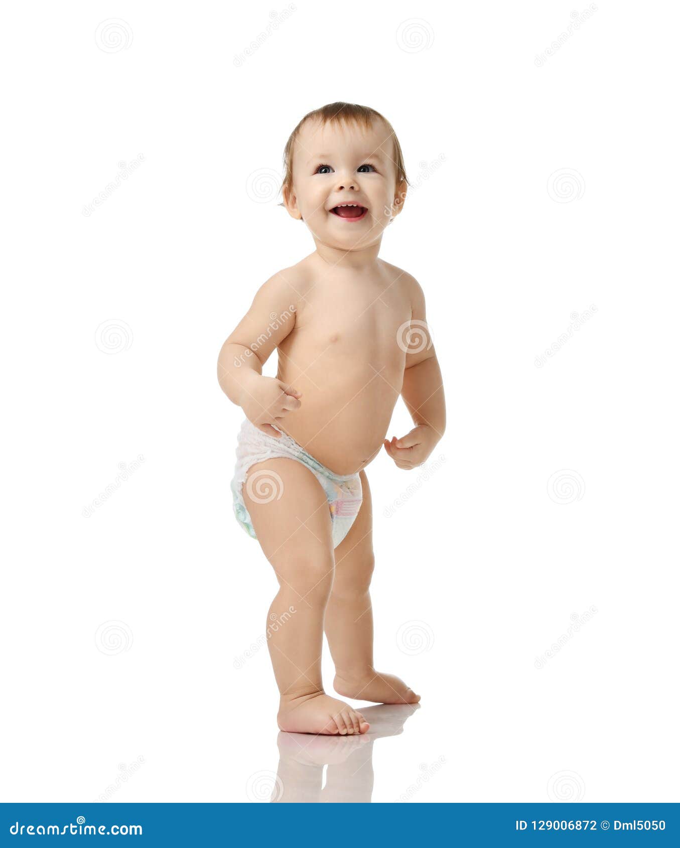 infant child baby girl kid toddler in diaper make first steps standing happy smiling laughing  on a white