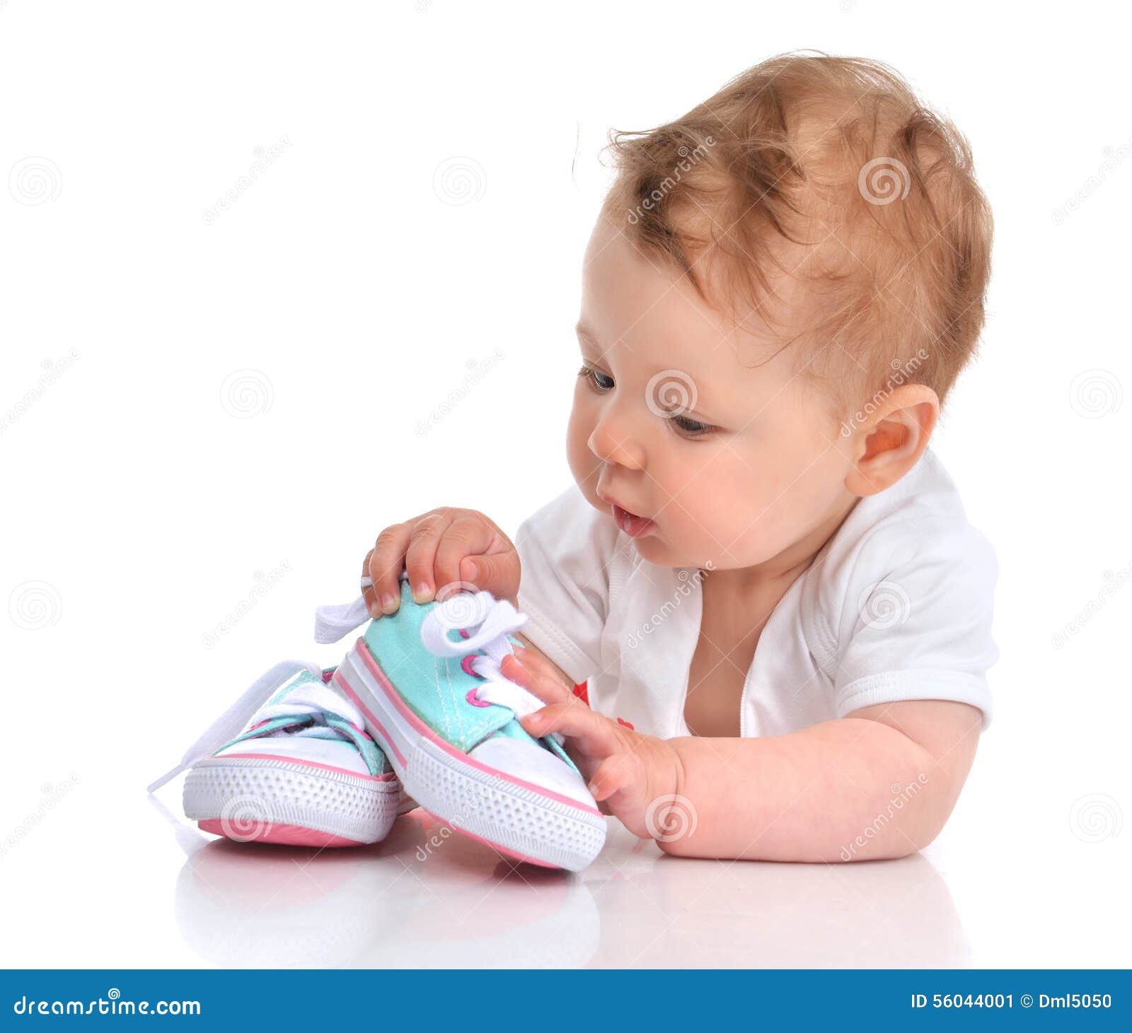 infant child baby girl lying happy searching new shoes 