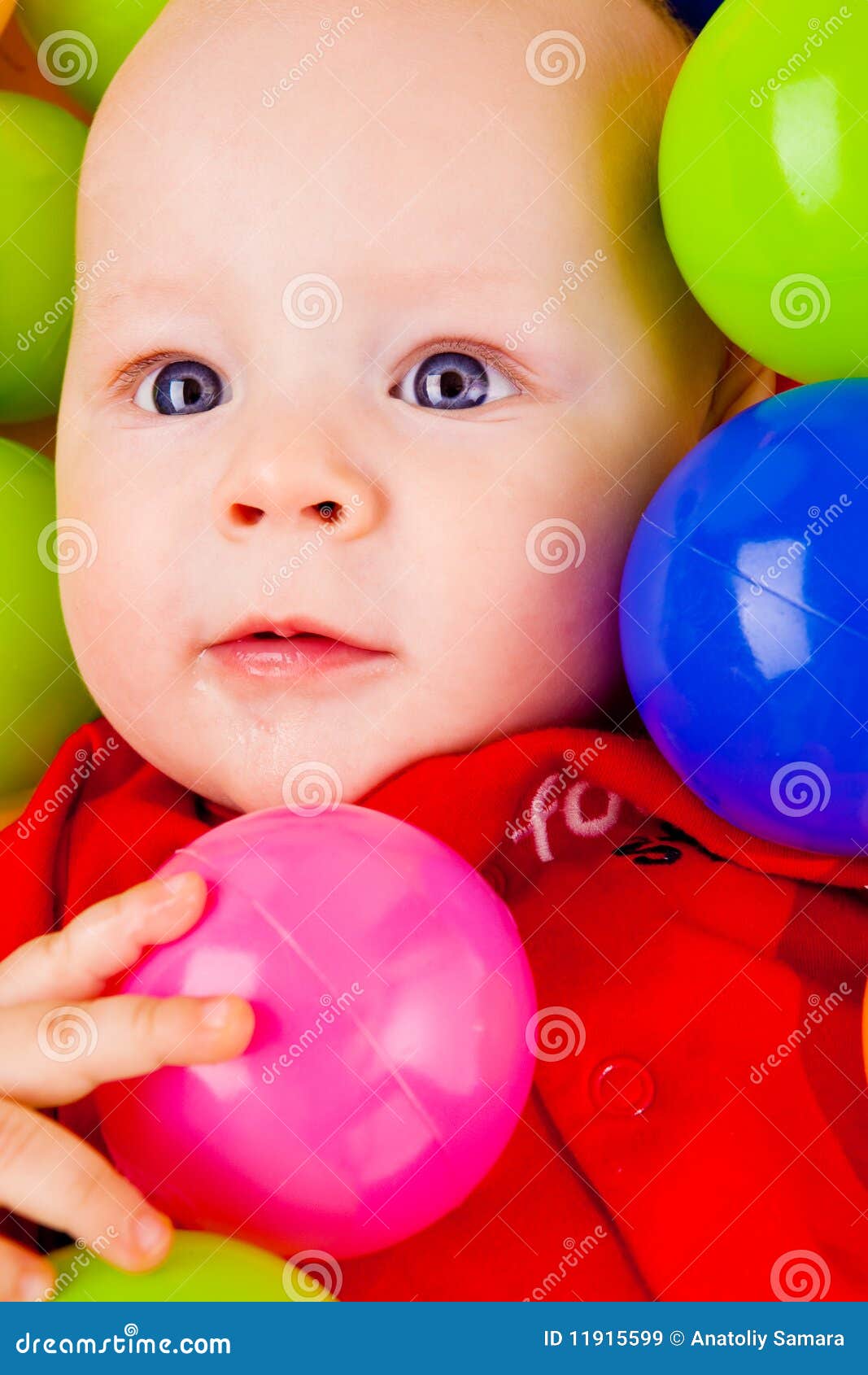 Infant with colorful balls stock image. Image of playful 11915599
