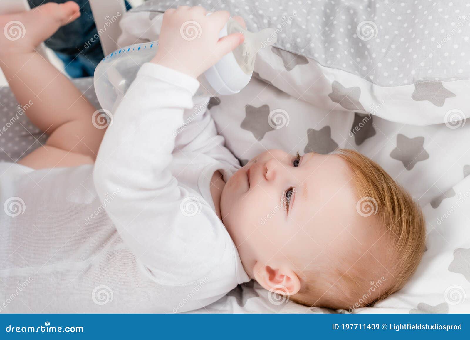 Infant Holding Baby Bottle while Lying Stock Image Image of cute