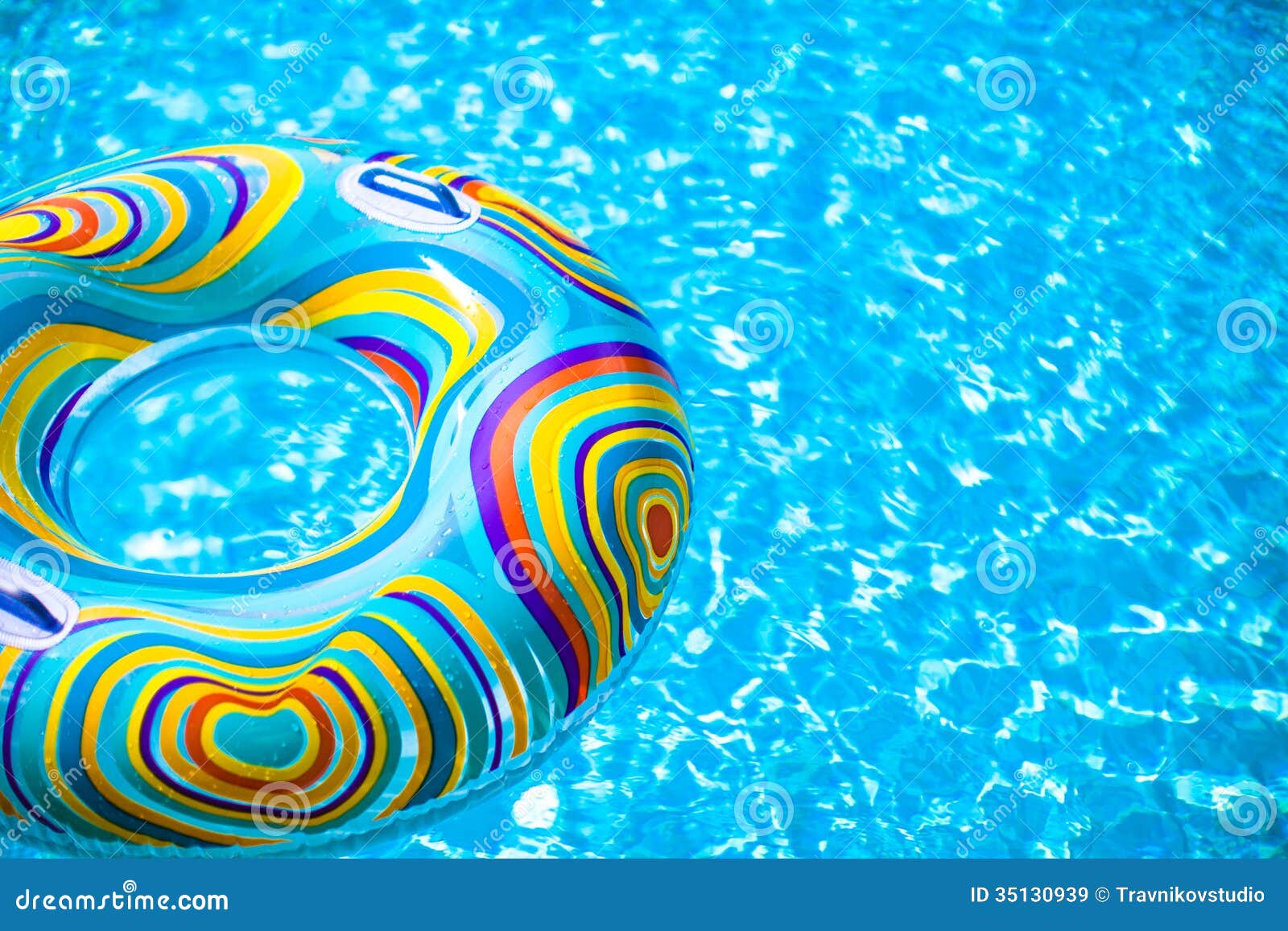 Inflatable Colorful Rubber Ring Floating In Blue Royalty Free Stock Images - Image: 35130939