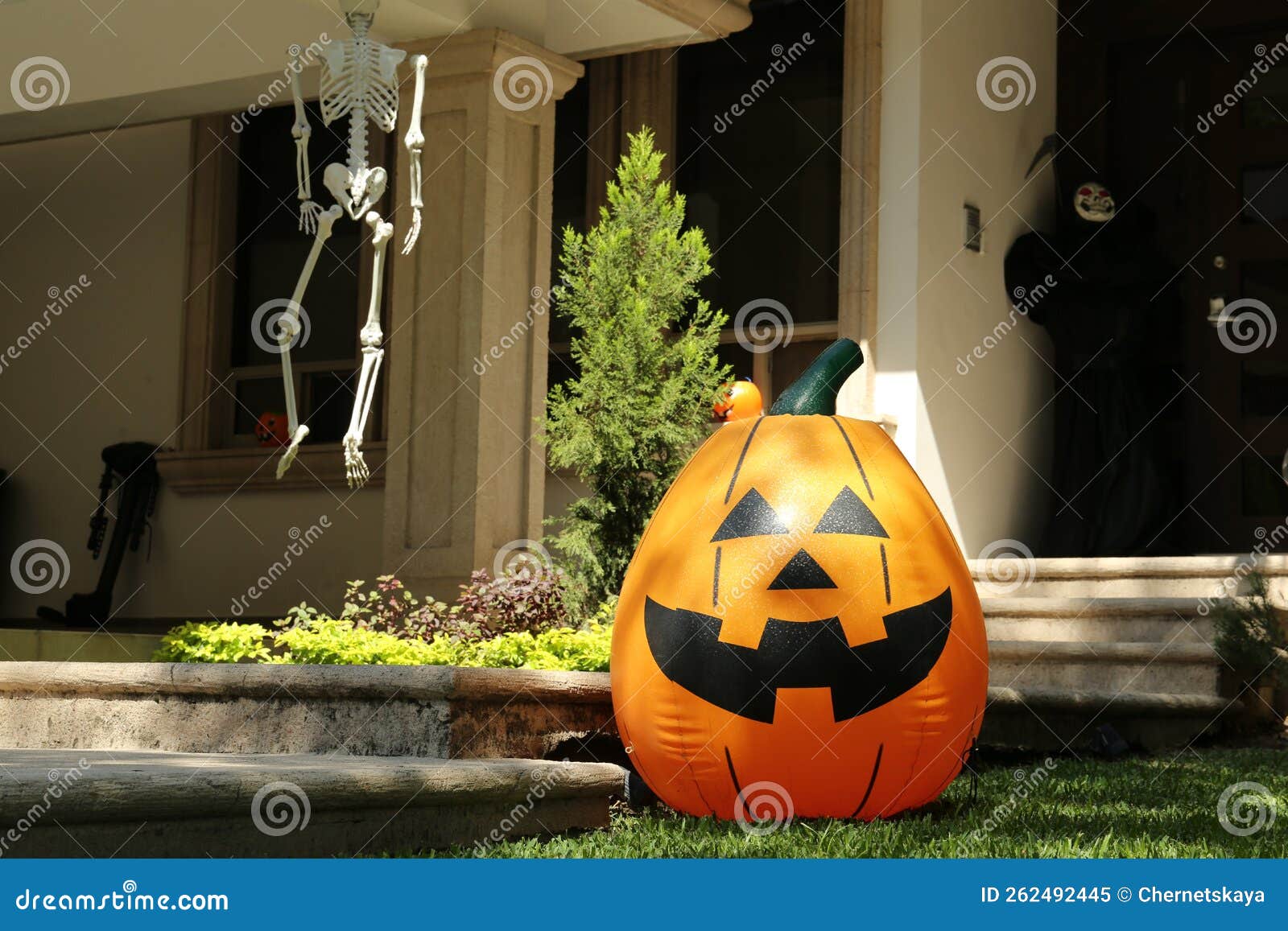 Inflatable Jack O`Lantern Near House Decorated for Halloween Stock