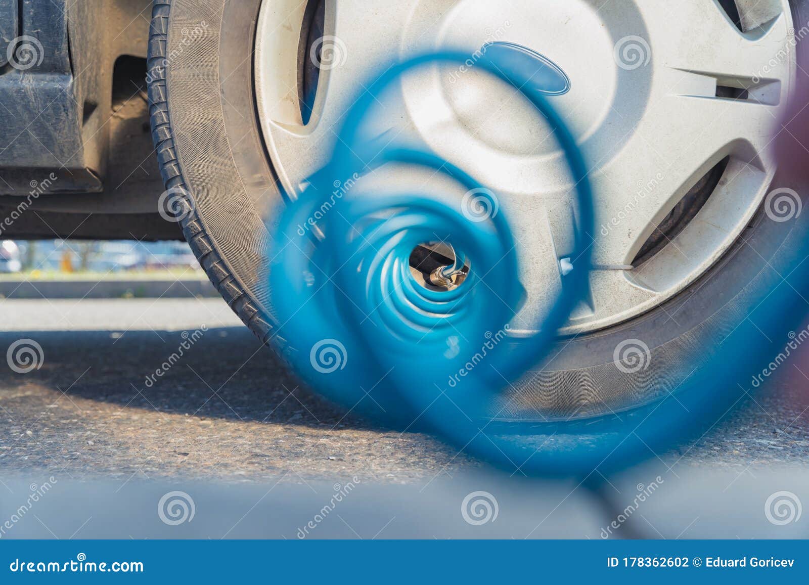 Inflating the Car Tires with Air Using a Compressor Stock Photo Image