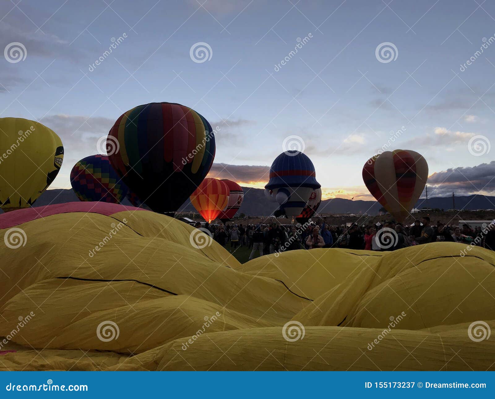 view of stages of inflation at the albuquerque international balloon fiesta with a beautiful sunrise.