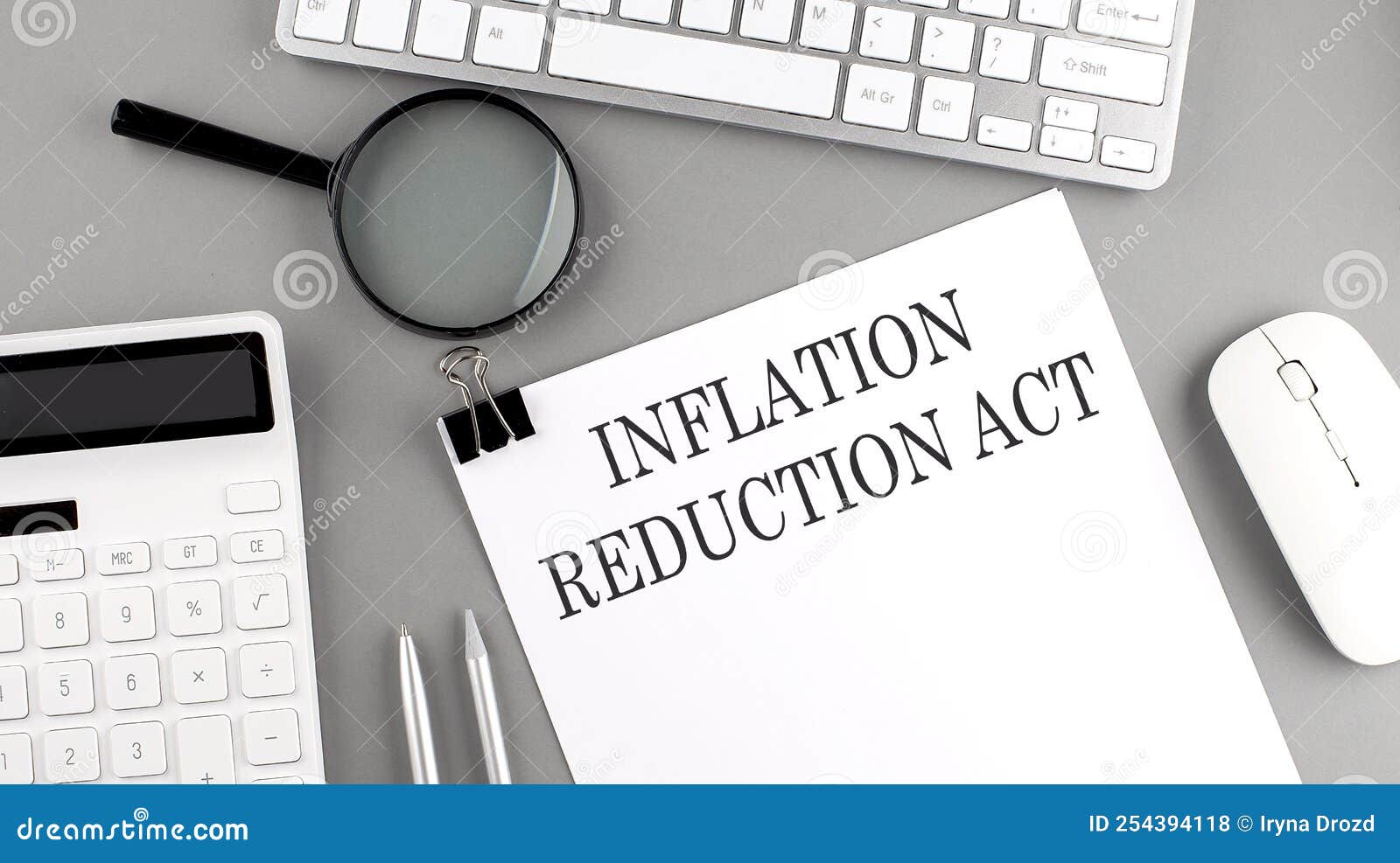 inflation reduction act written on paper with office tools and keyboard on the grey background
