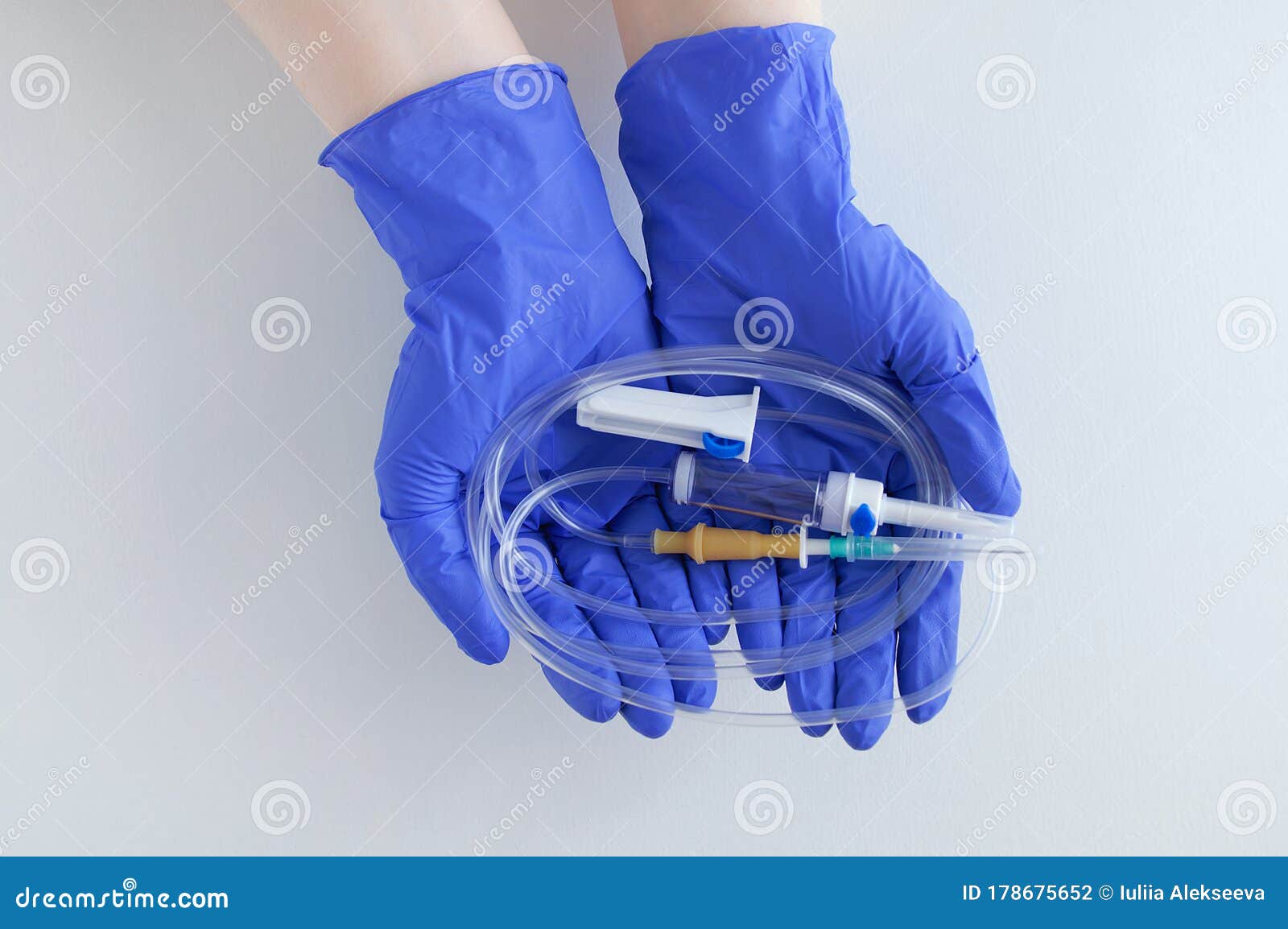 Infusion System with a Needle on the Palms in Protective Blue Surgical