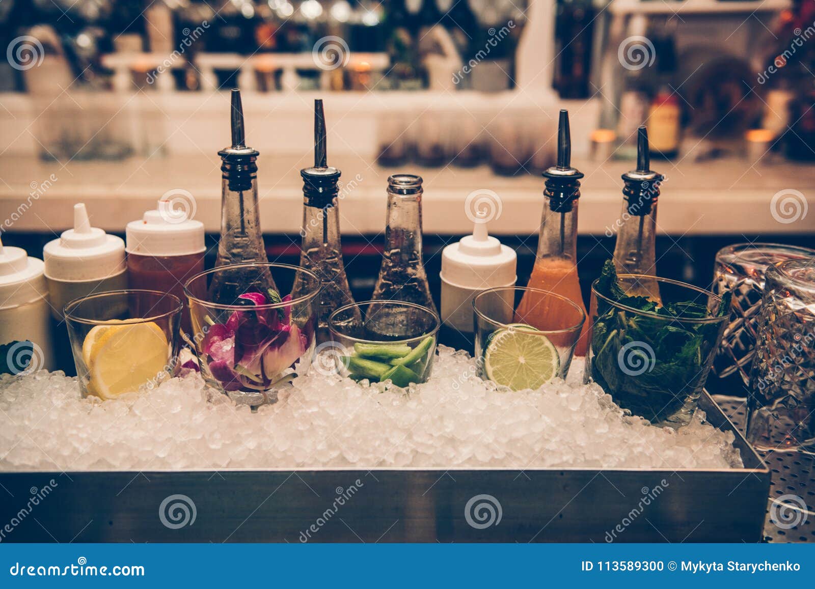 ingredients and syrups for cocktails at bar counter in the the nightclub.