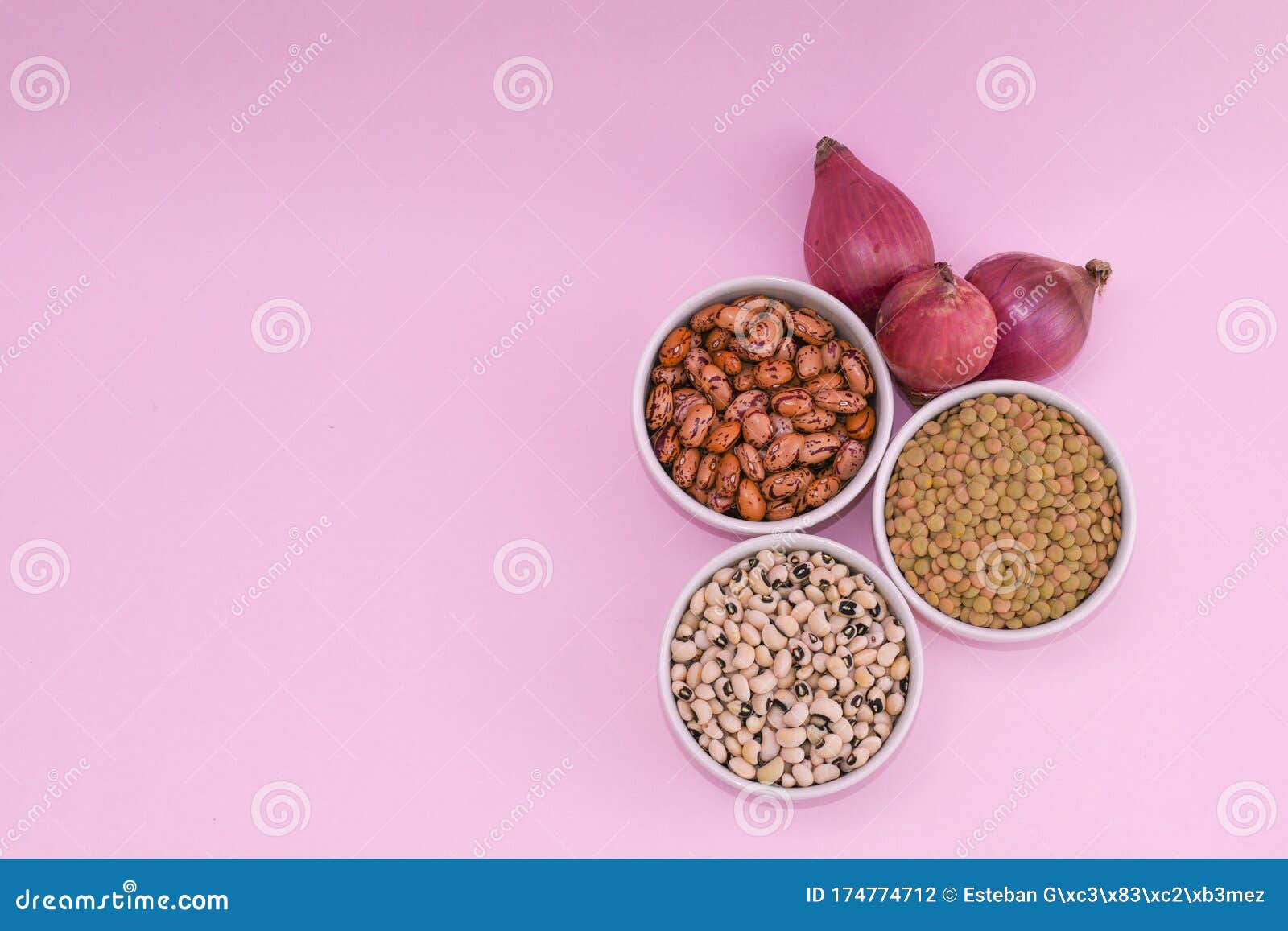 ingredients to make a vegan and vegetarian meal.  lentils and beans for healthy food.  organic legumes on pink background, onion