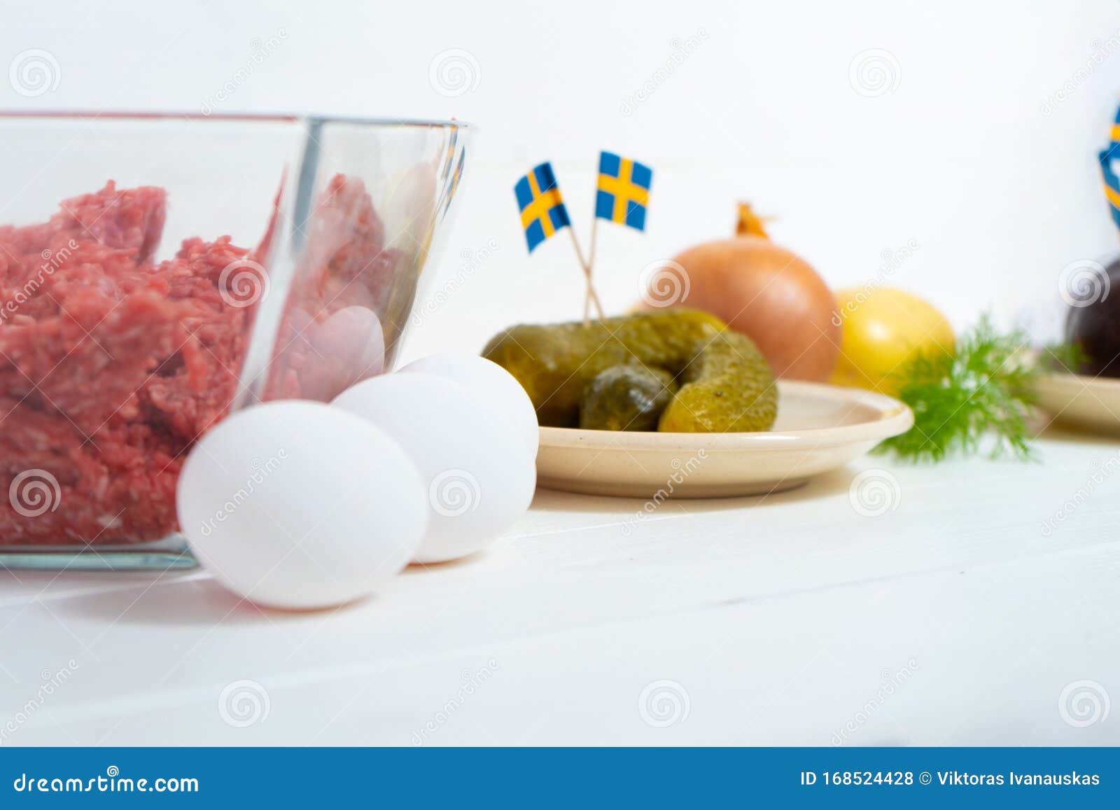ingredients for a traditional swedish dish beef lindstrom. freshly minced beef, boiled potato, white chopped onion, pickles, pickl