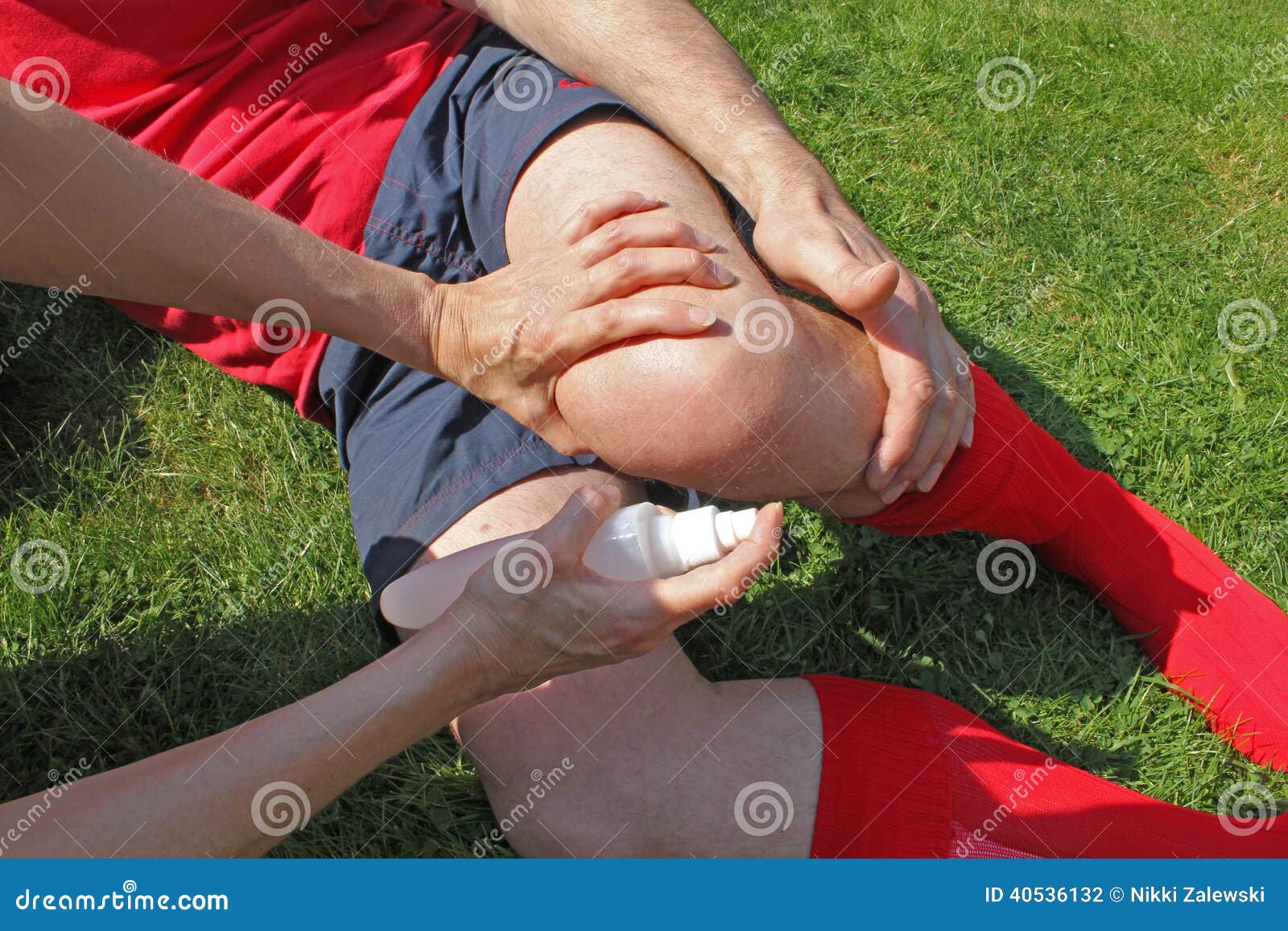 injured sportsman being helped by therapist