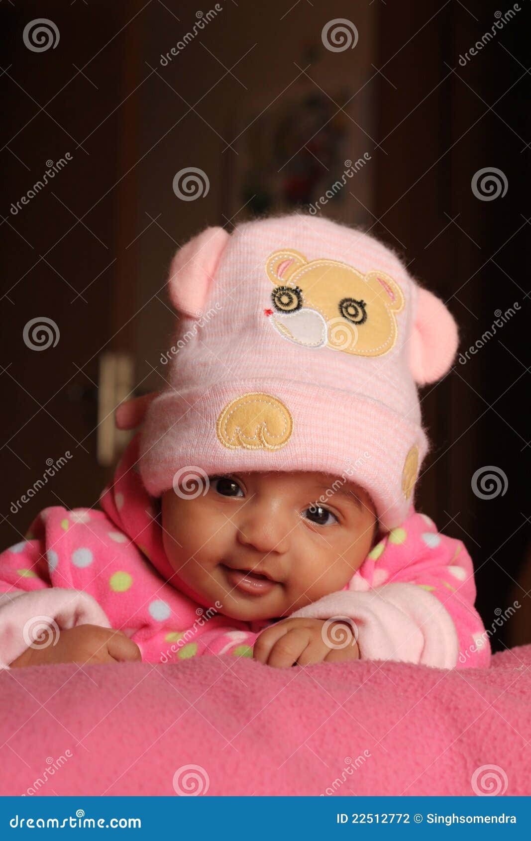 innocent asian baby girl in pink winter cap