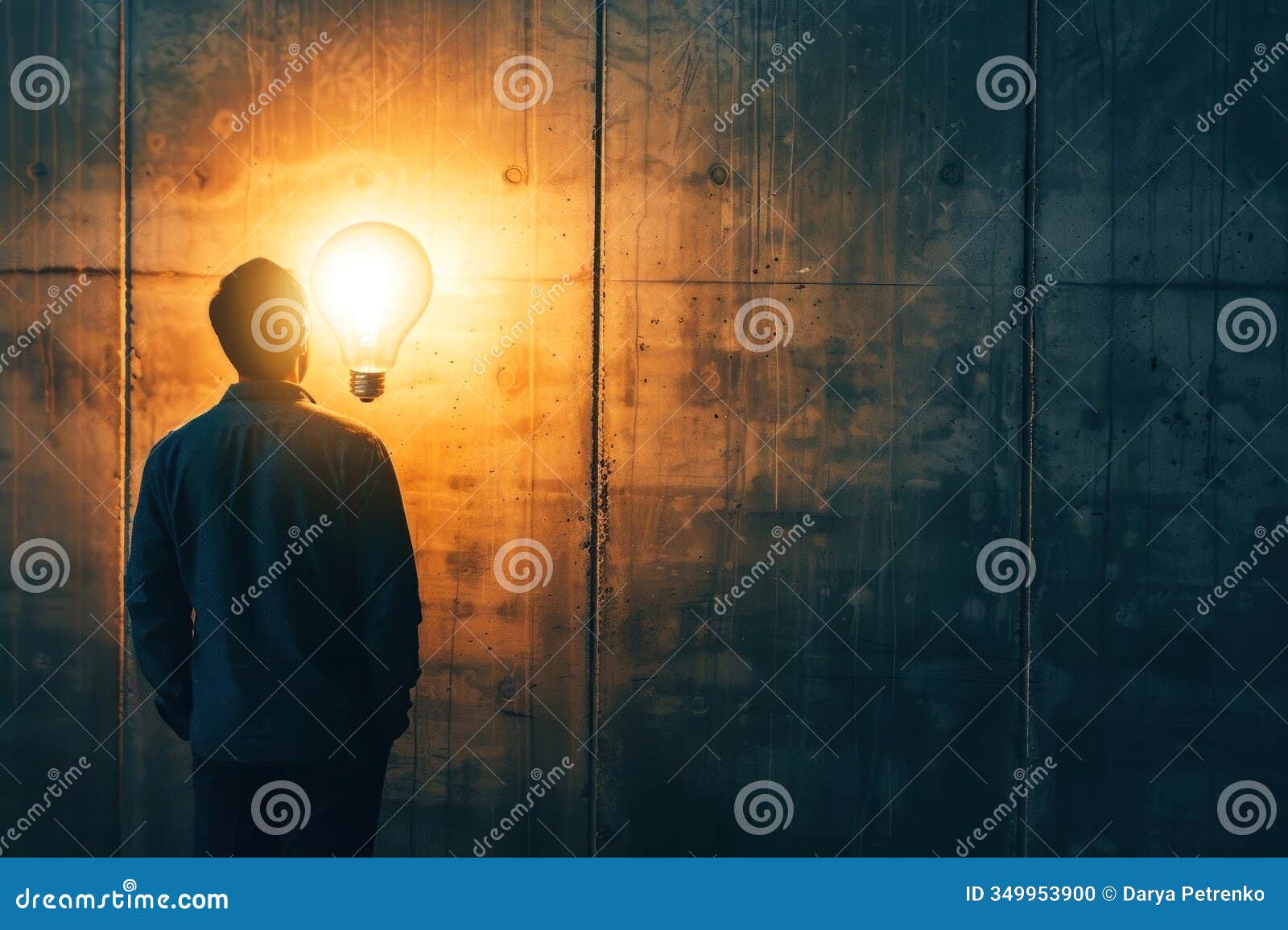 innovative art piece showing a man staring at a radiant light bulb in front of a textured wall