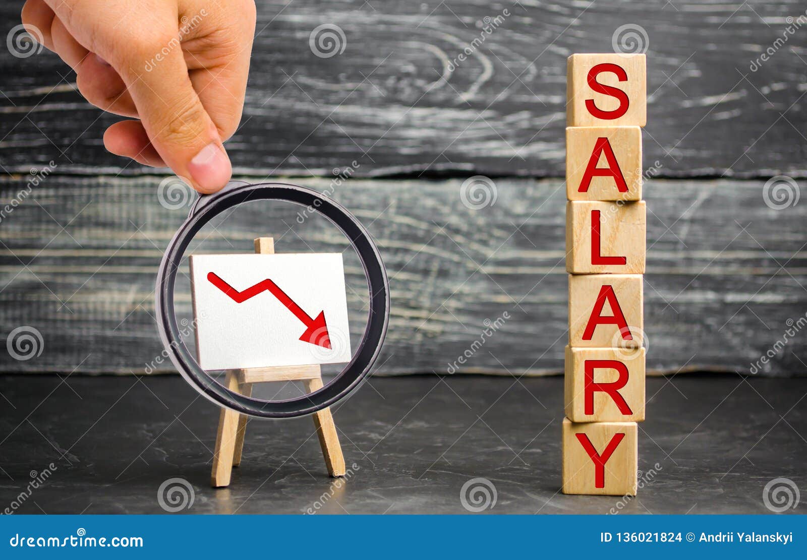 the inscription `salary` and the red arrow down. lower salary, wage rates. demotion, career decline. lowering the standard of livi