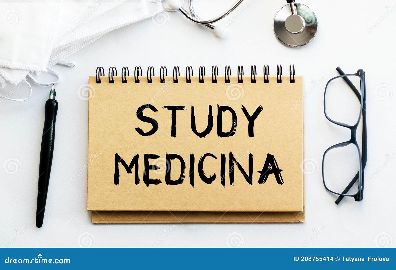 inscription - study medicina. written in a notepad to remind you of what's important. top view of the table along with a