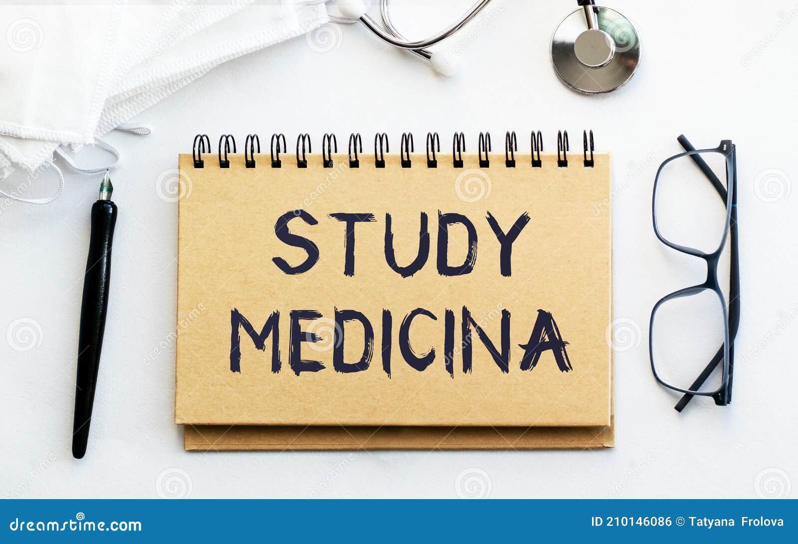 inscription - study medicina. written in a notepad to remind you of what`s important. top view of the table along with a