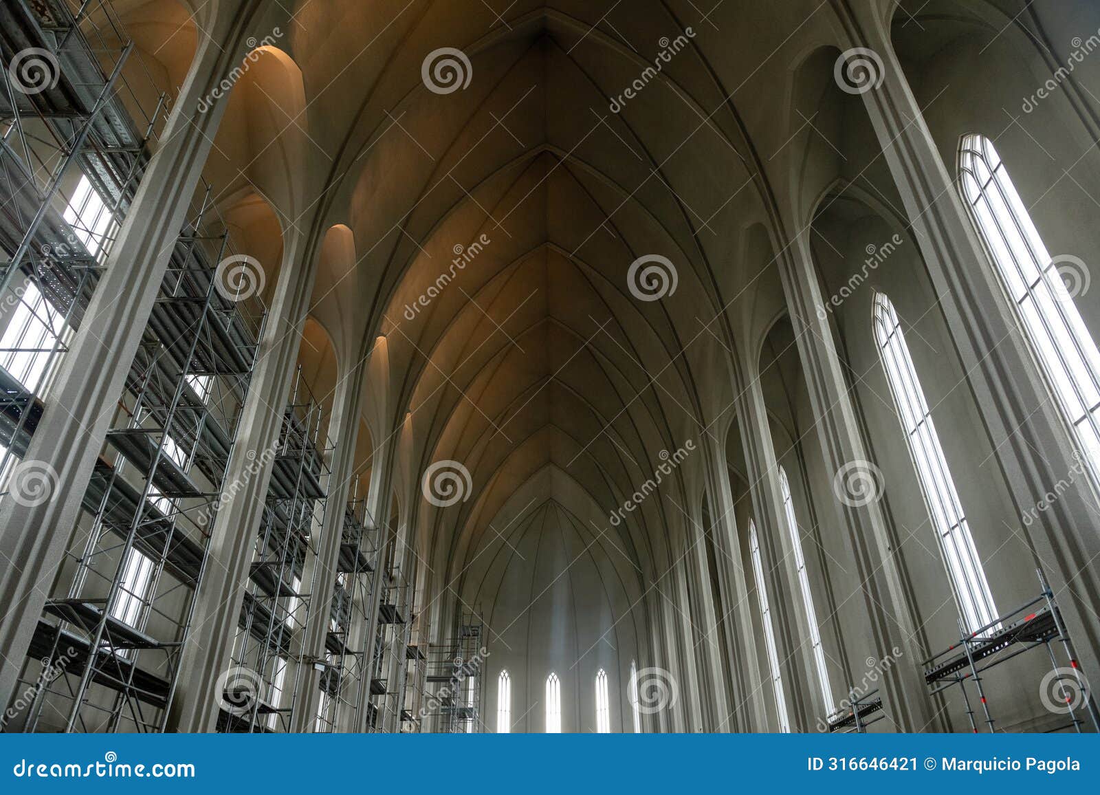 the inside of a church with a lot of arches and windows