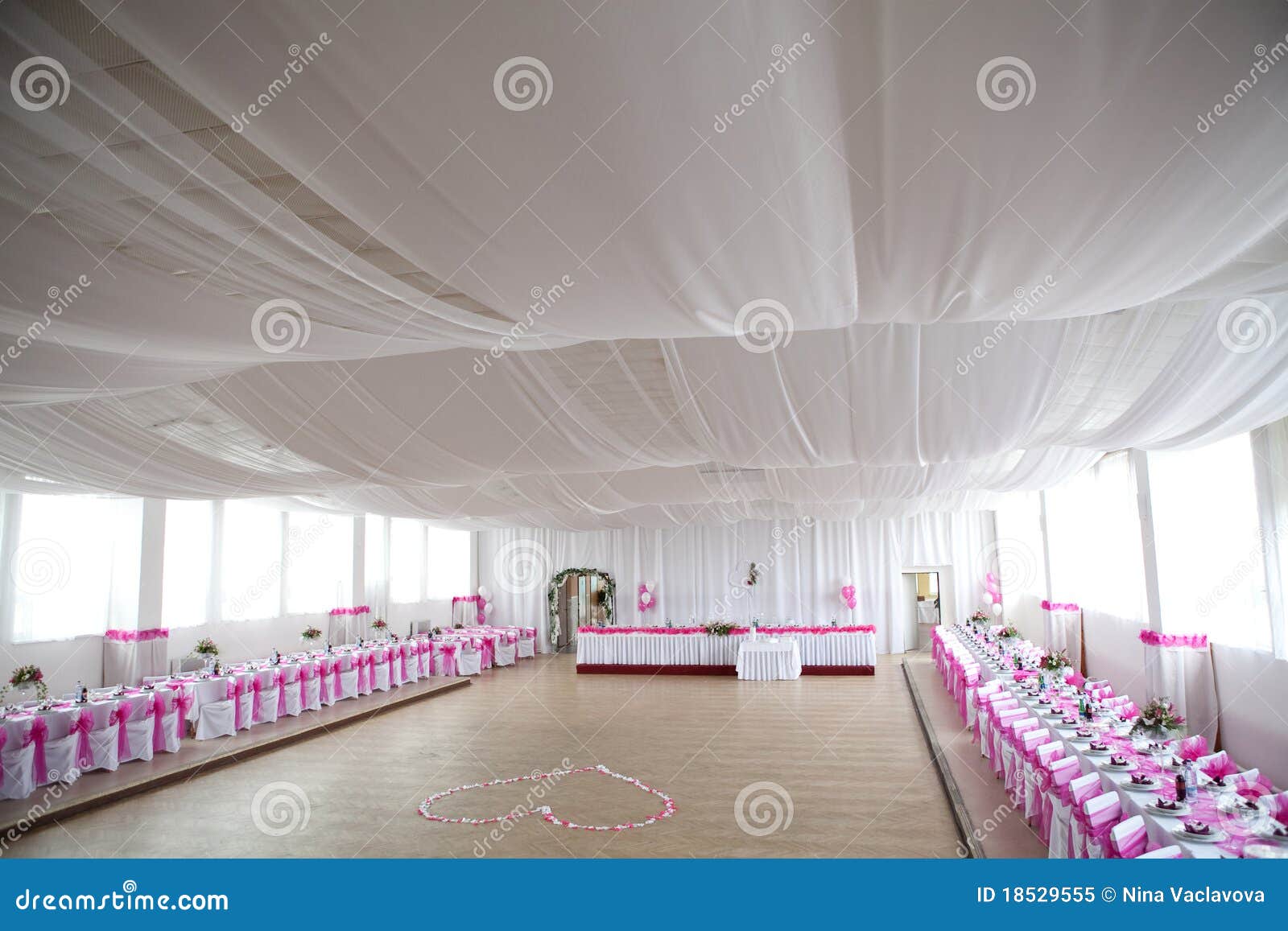 the inside of a massive white wedding tent with ta