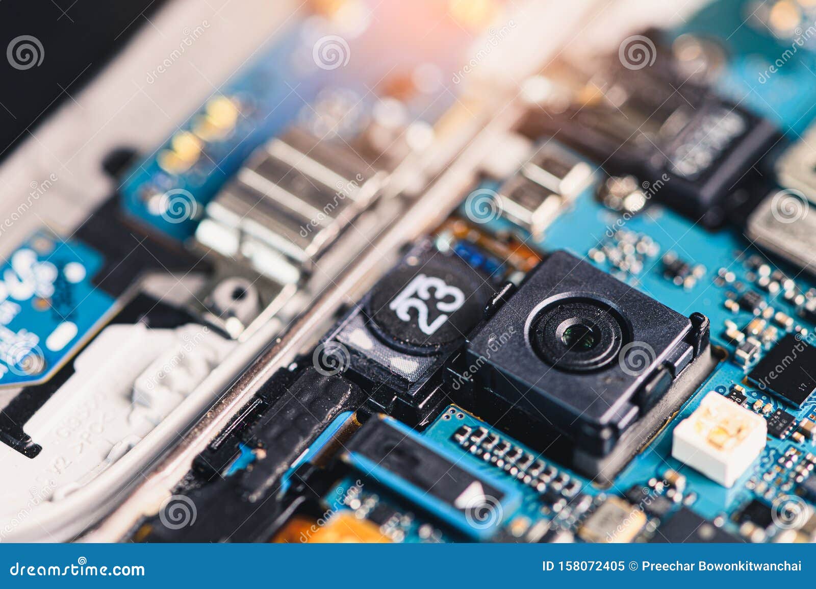 the inside of the smartphone`s motherboard and sim card lay on the back table. the concept of computer hardware, mobile phone, ele