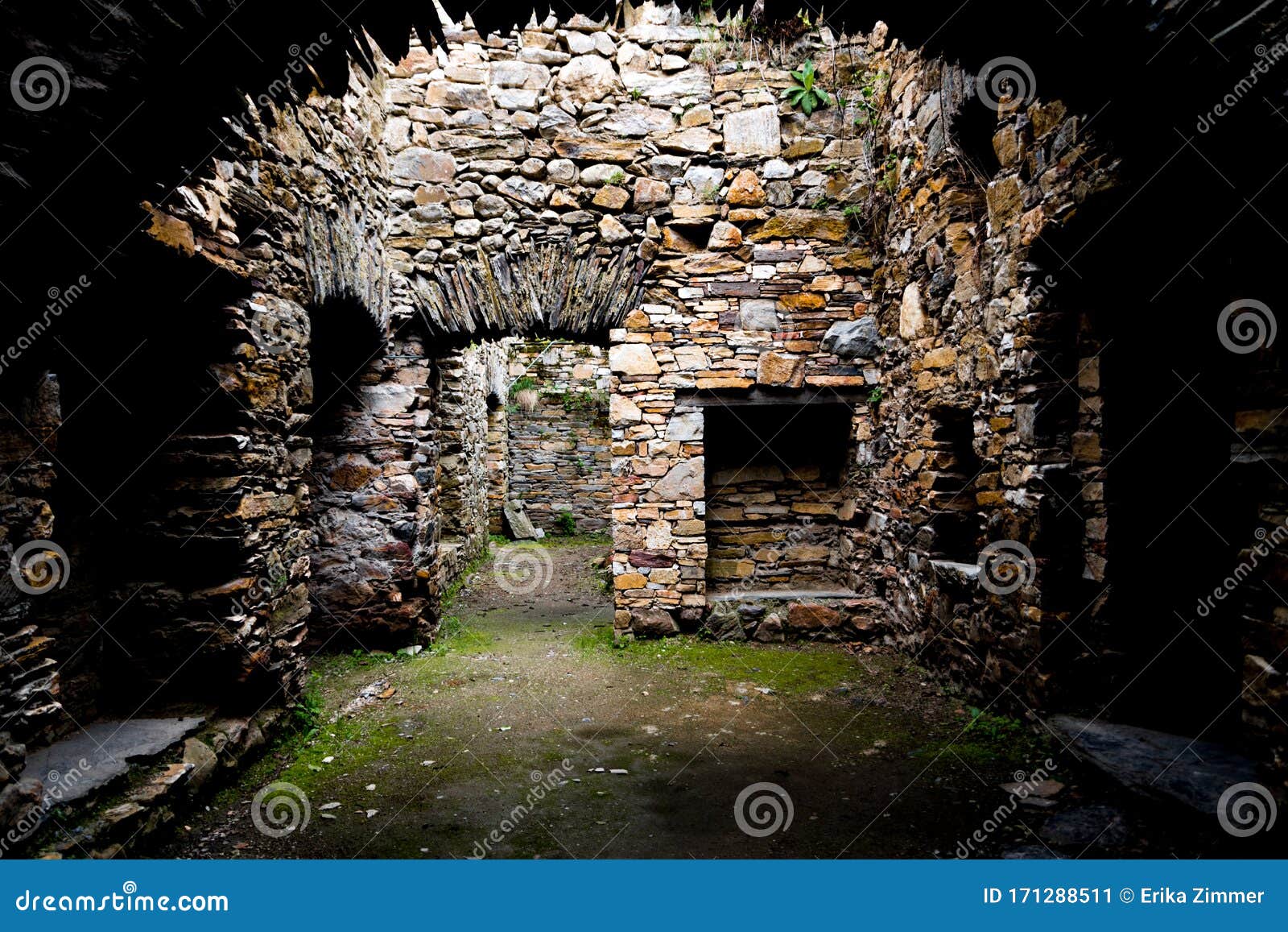 inside view of an old monastery, made of stone and without a roof.