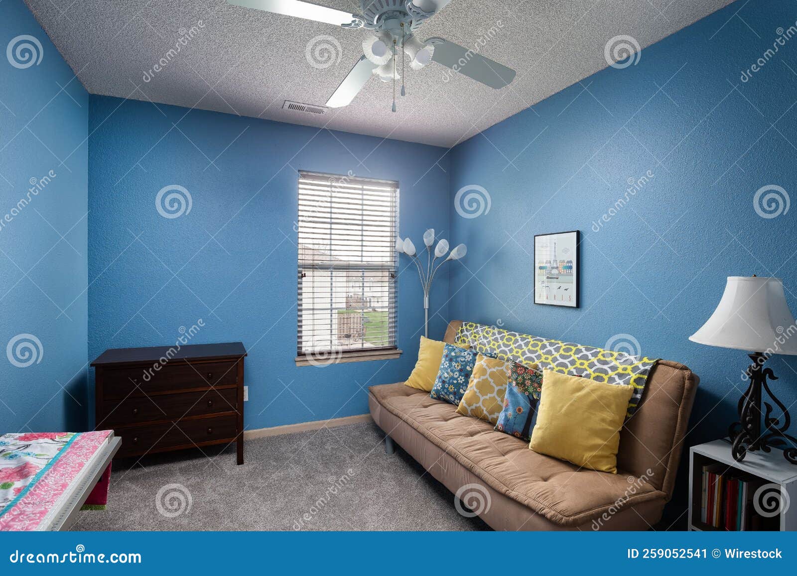 Inside View of a Small Bedroom with Blue Walls, a Digital Piano, and a Couch Editorial Photo