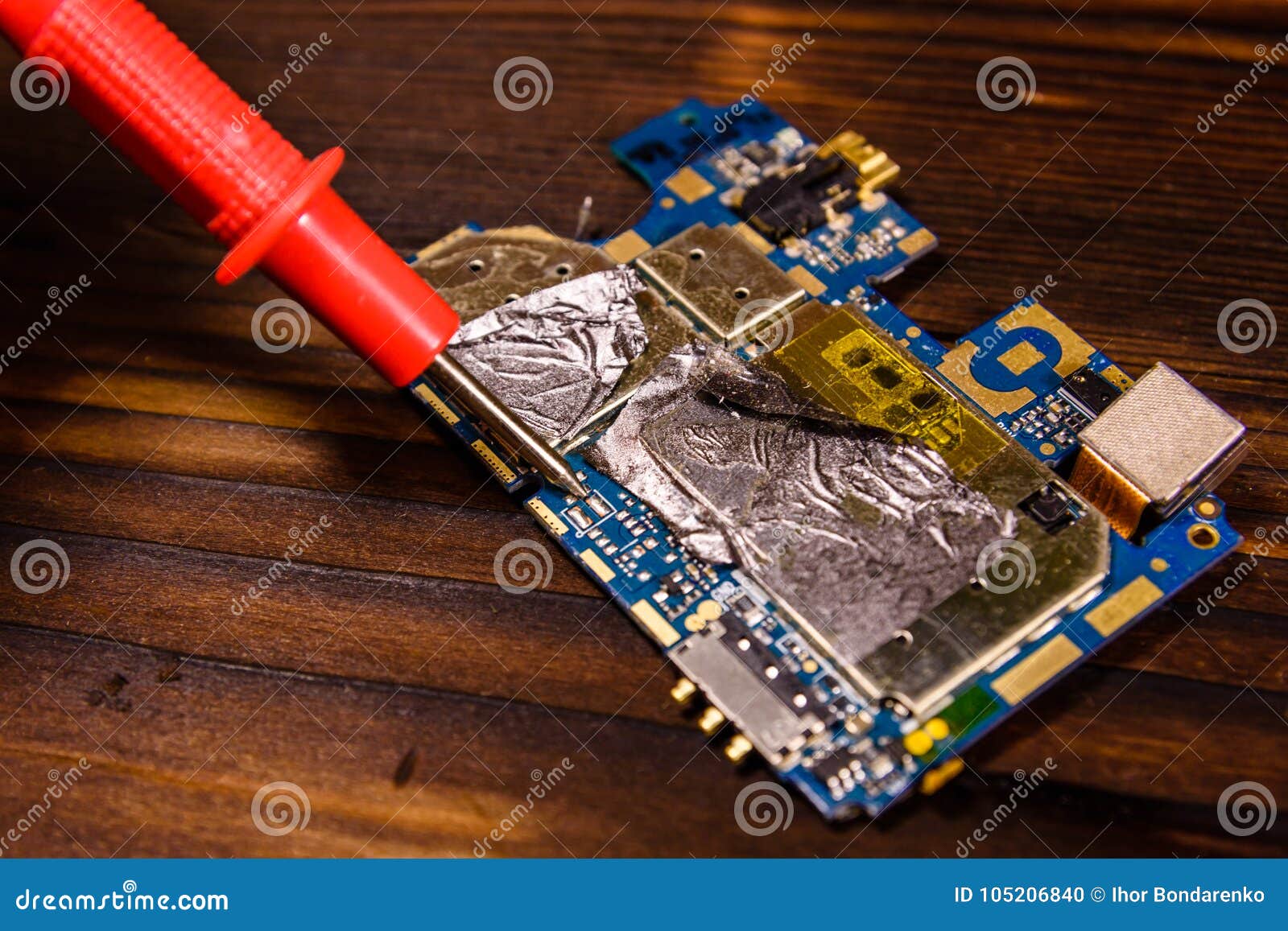 Inspecting of the Electronic Circuit Board with Multimeter Stock Photo