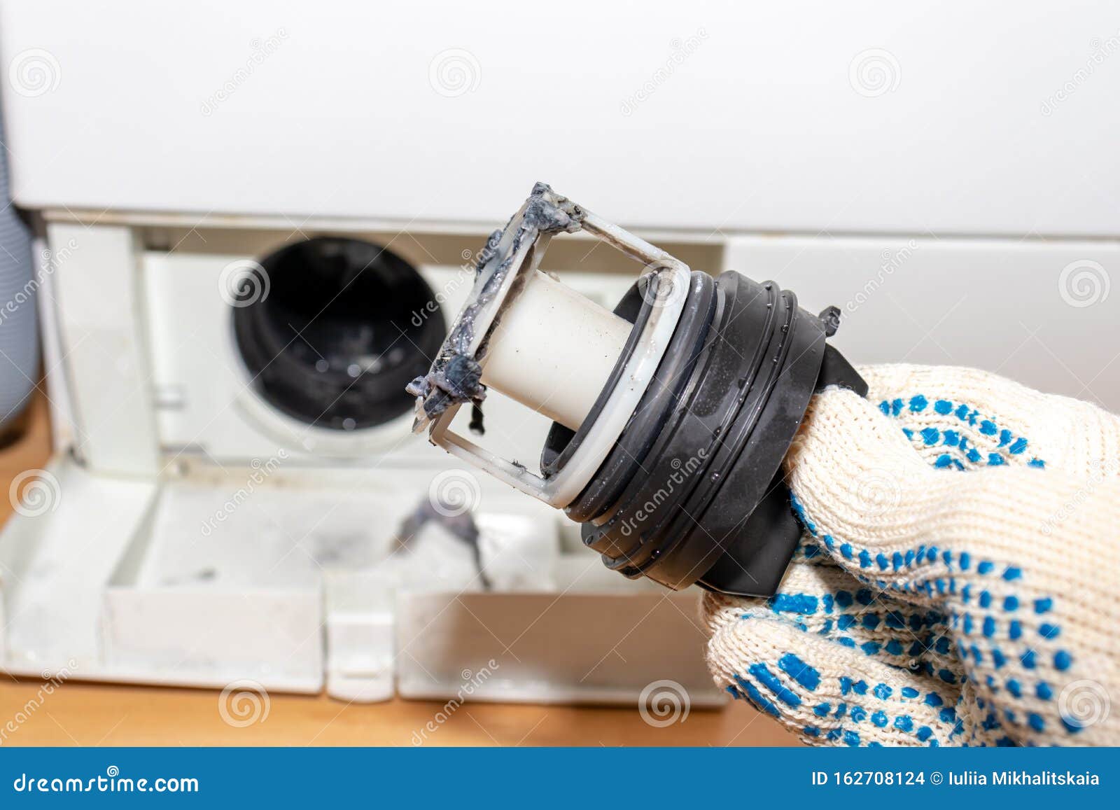 Inspecting Washing Machine`s Dirty Clogged Drain Pump Filter Close Up