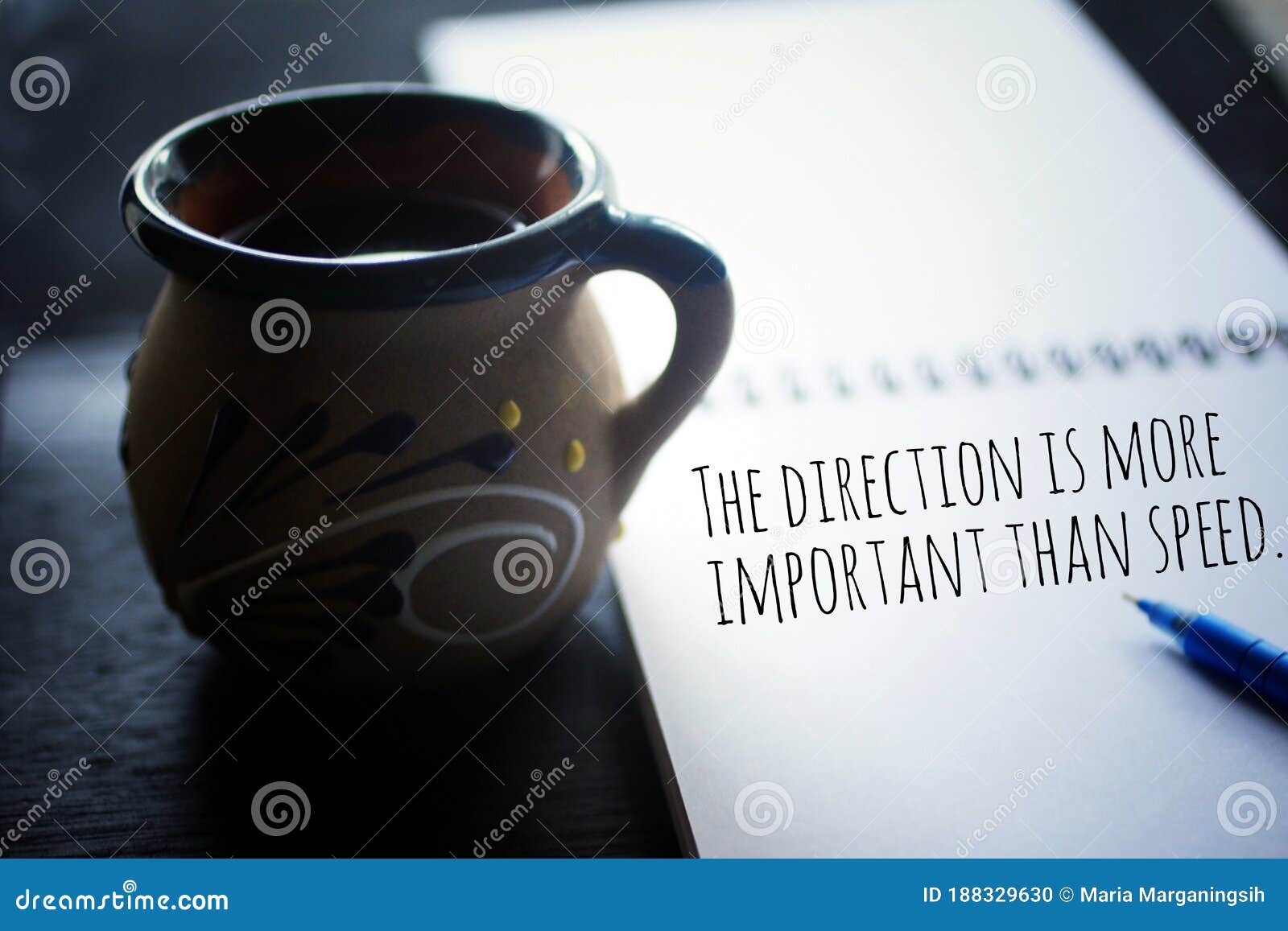 inspirational motivational quote - the direction is more important than speed. text message on paper book with a cup of coffee.