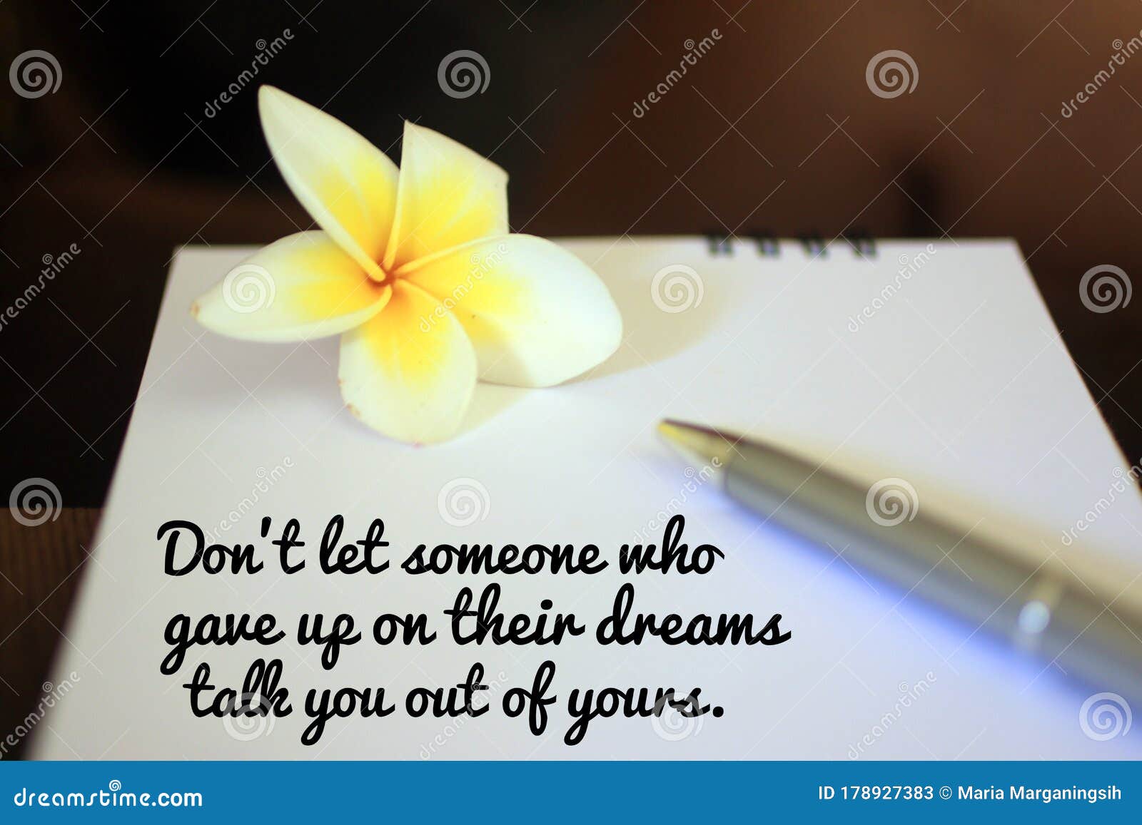 inspirational motivational quote - do not let someone who gave up on their dreams talk you out of yours. message on notebook.