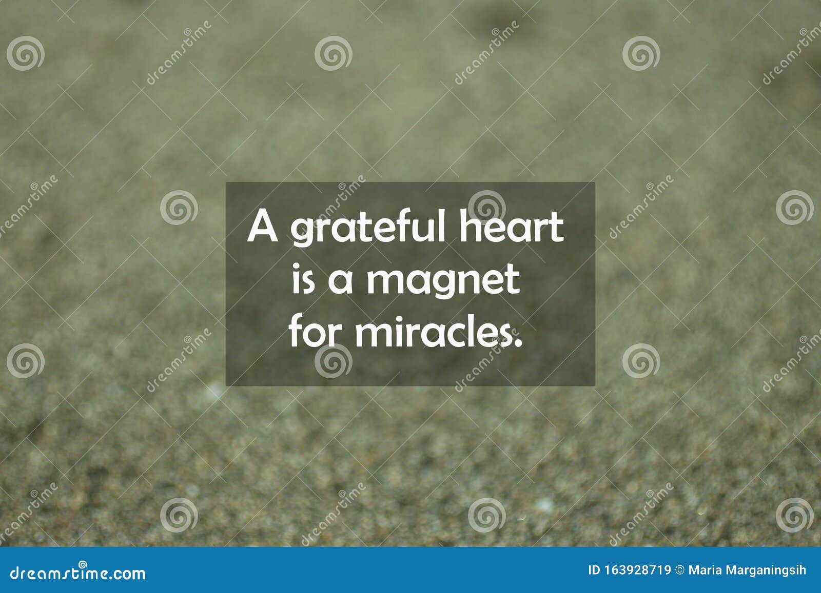 inspirational motivational quote - a grateful heart is a magnet for miracles. with blurry black sands pattern texture background.