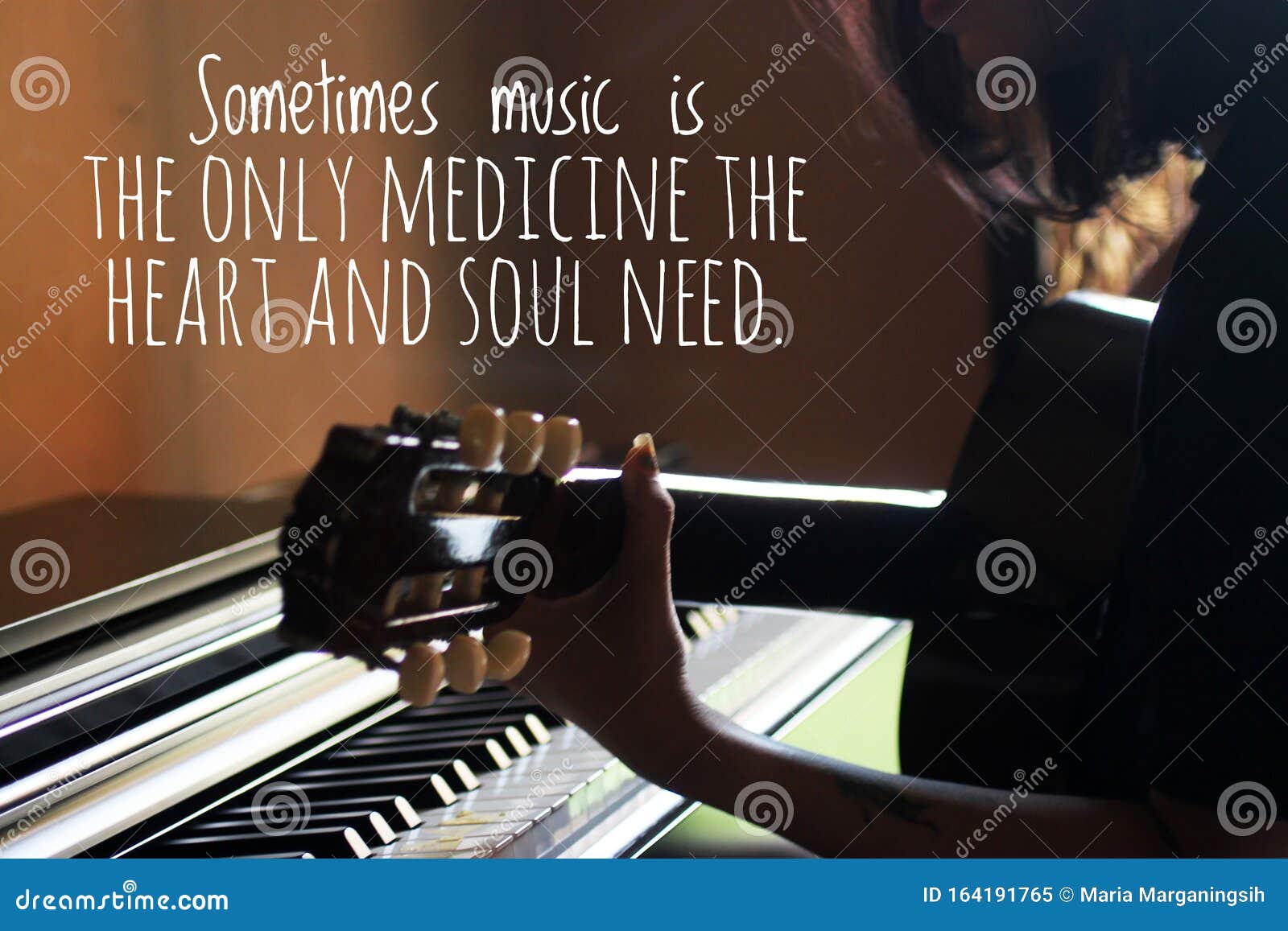 inspirational words - sometimes music is the only medicine the heart and soul need. with silhouette of young woman playing guitar